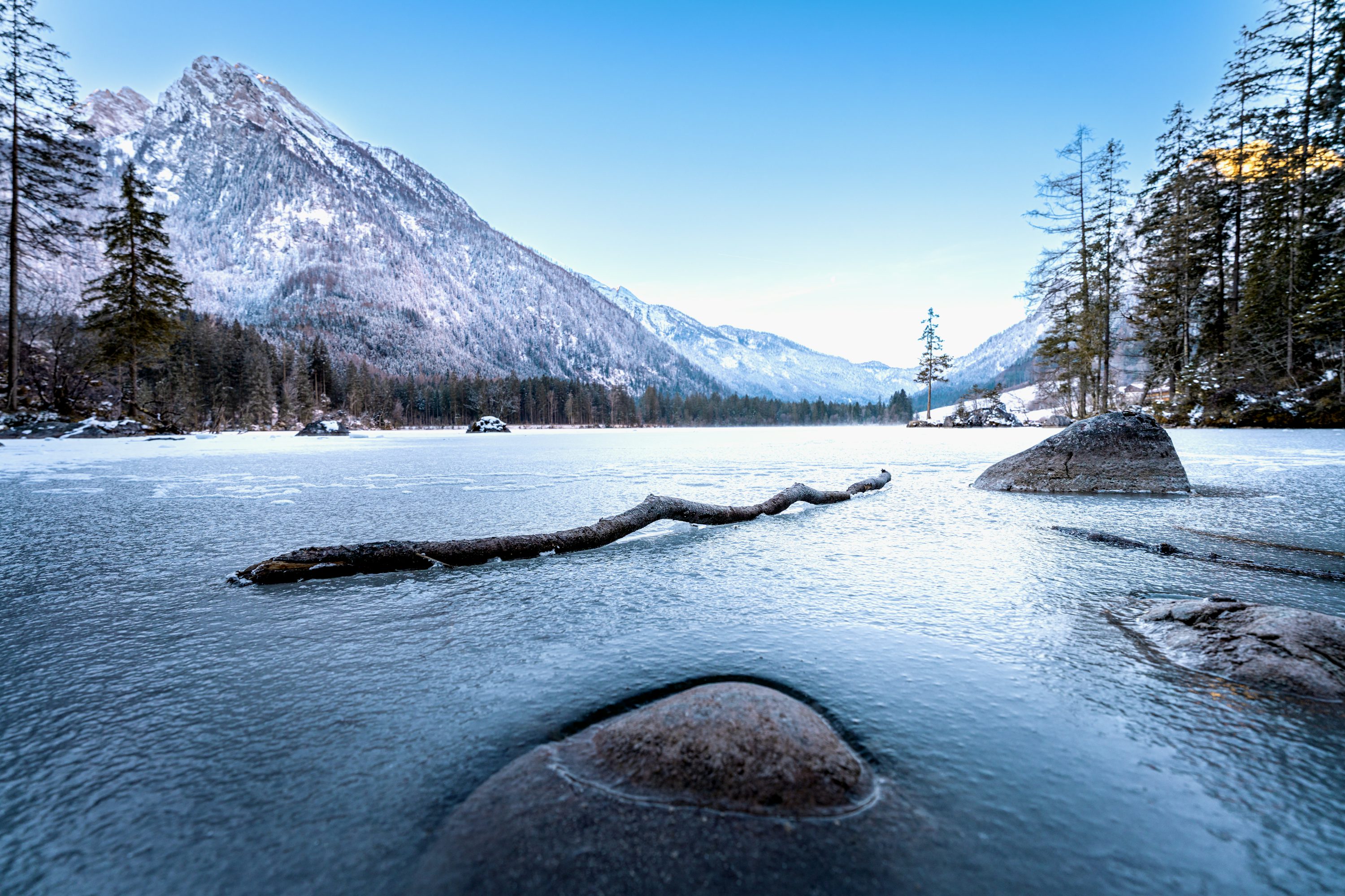 Frozen lake and snowy mountains create a serene landscape. photo