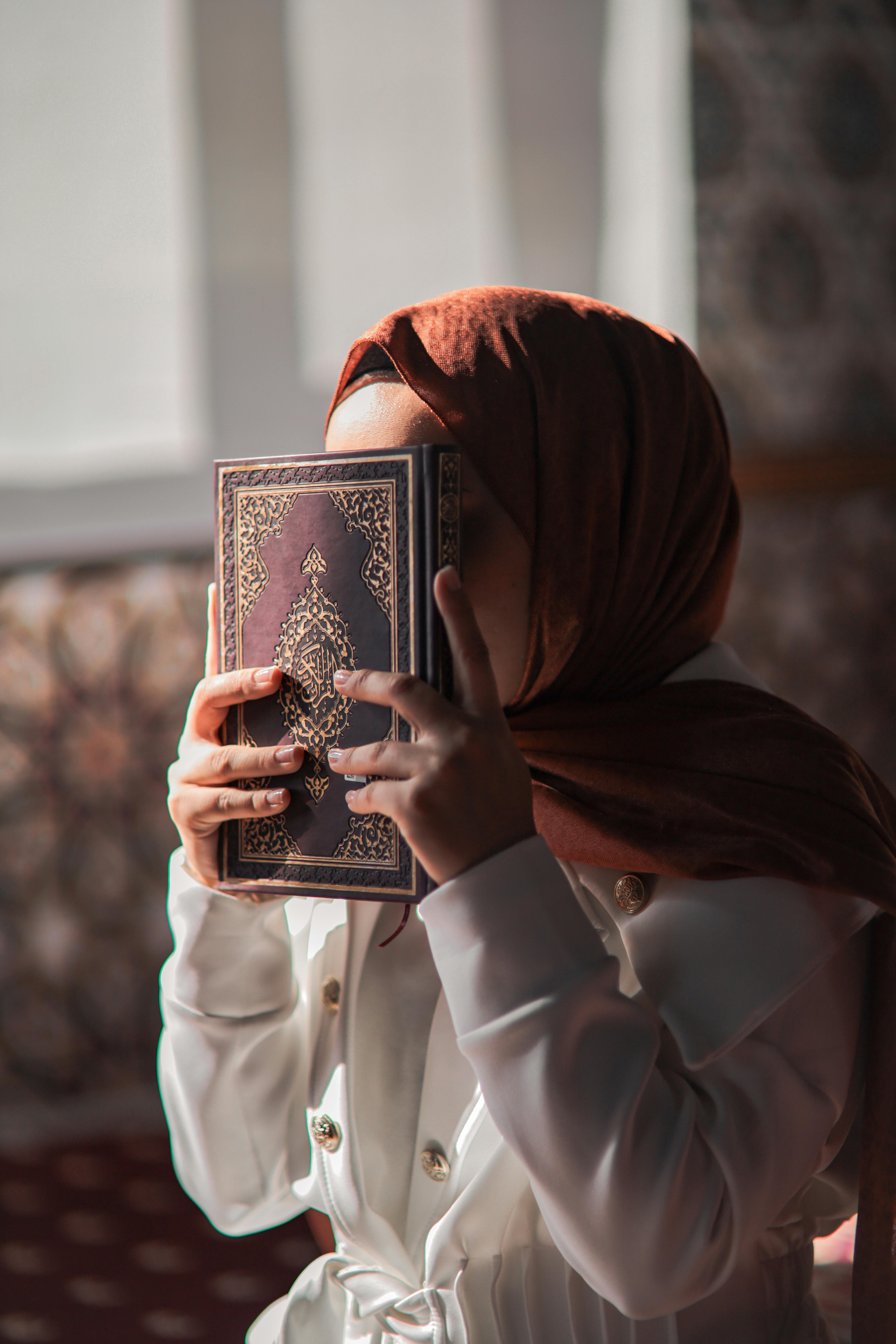 Portrait of Woman Holding Koran · Free