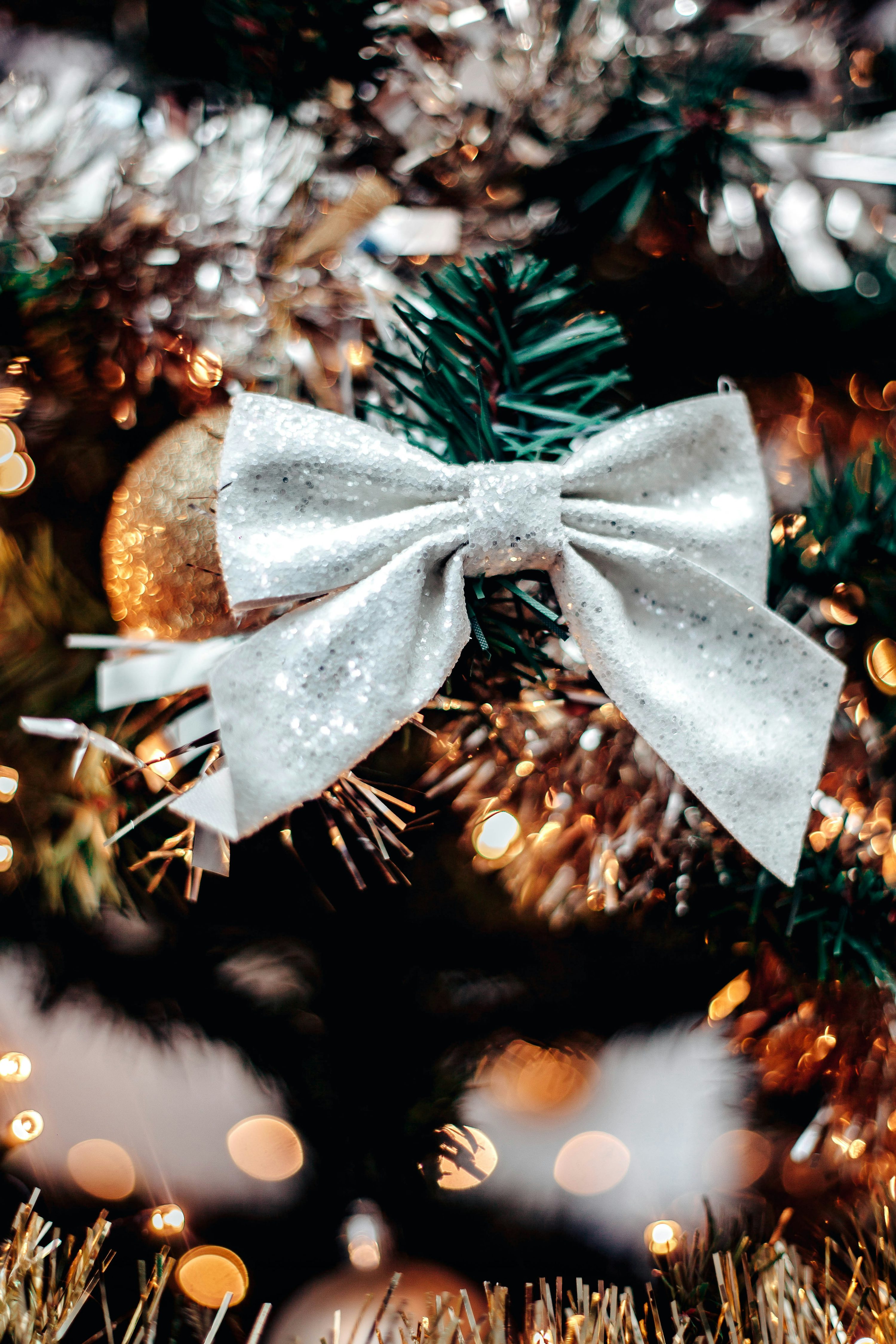 A close up of a christmas tree with a bow on it photo