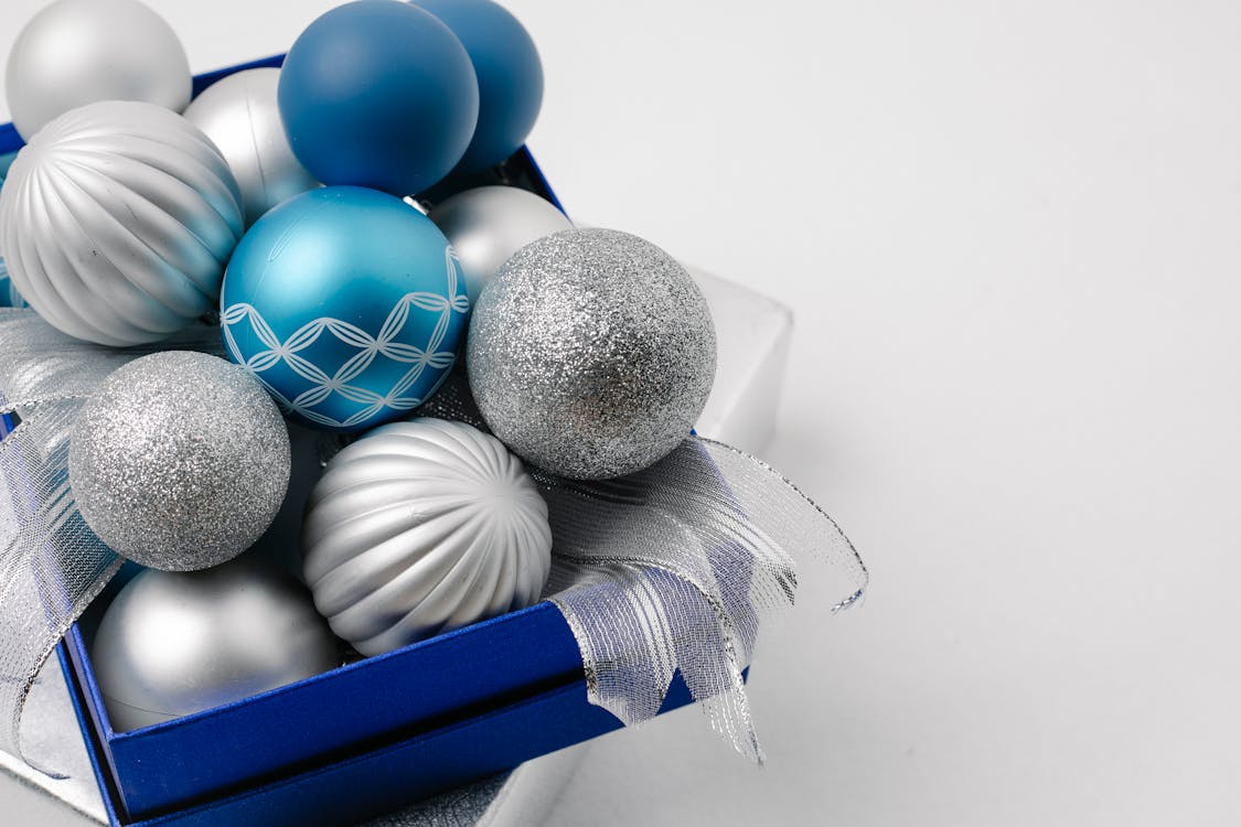 Festive sparkling silver and blue baubles in box · Free