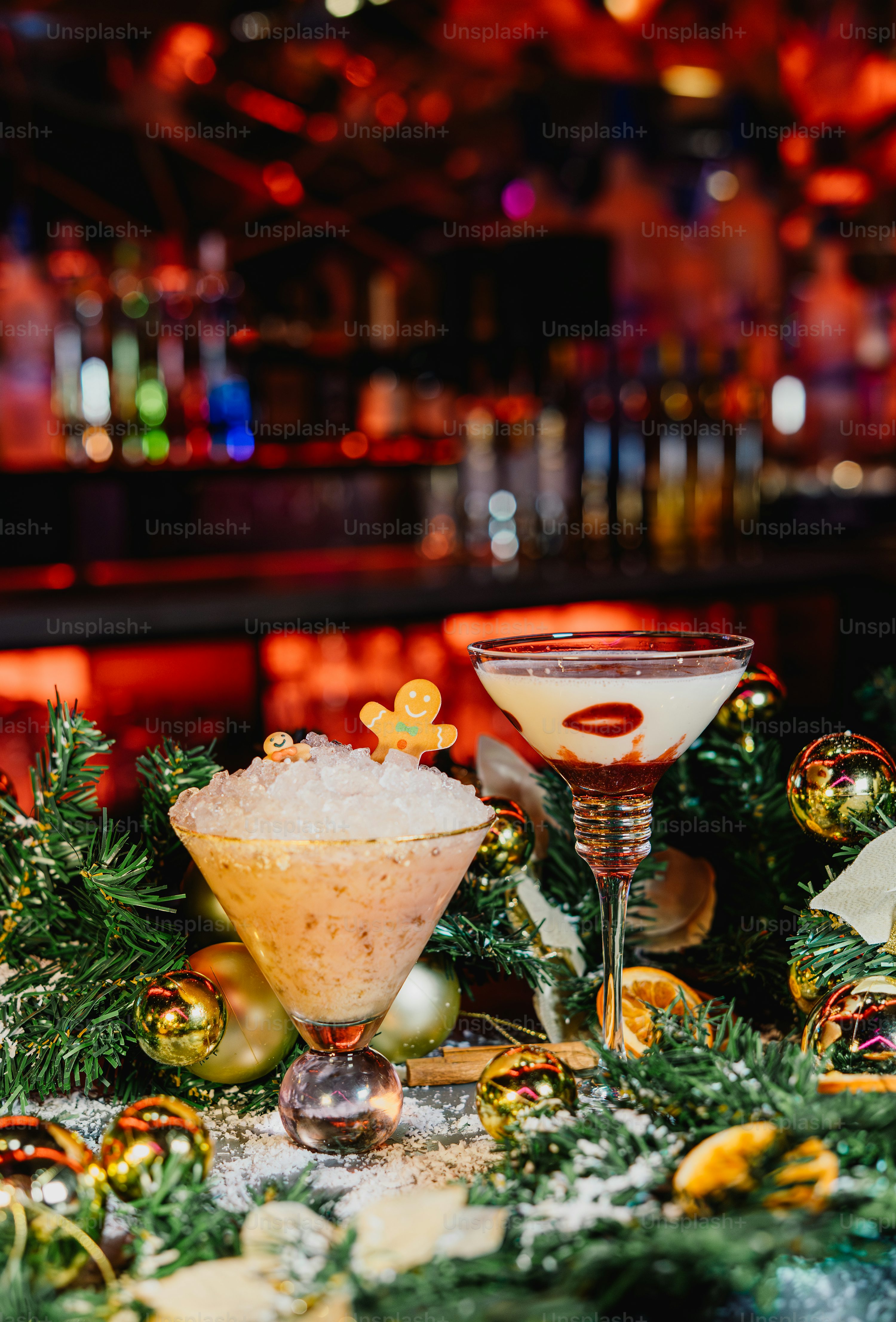 Two festive holiday cocktails decorated with gingerbread and berries photo