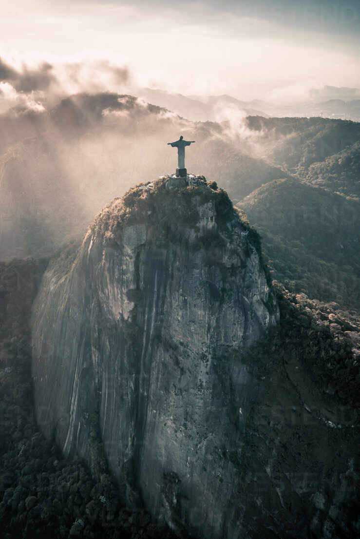 Aerial View Of Afternoon Light Rays Shining Upon Christ The Redeemer Statue On Corcovado Mountain In Rio De Janeiro, Brazil