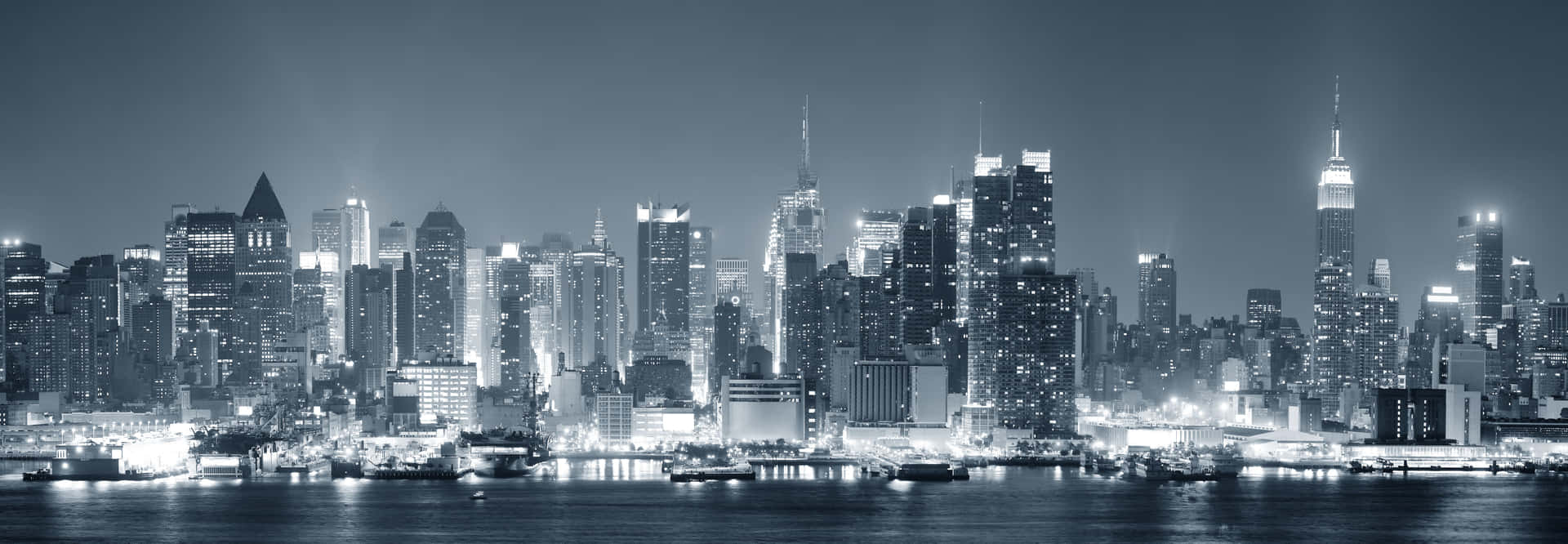 Download A Black And White Photo Of A City Skyline At Night