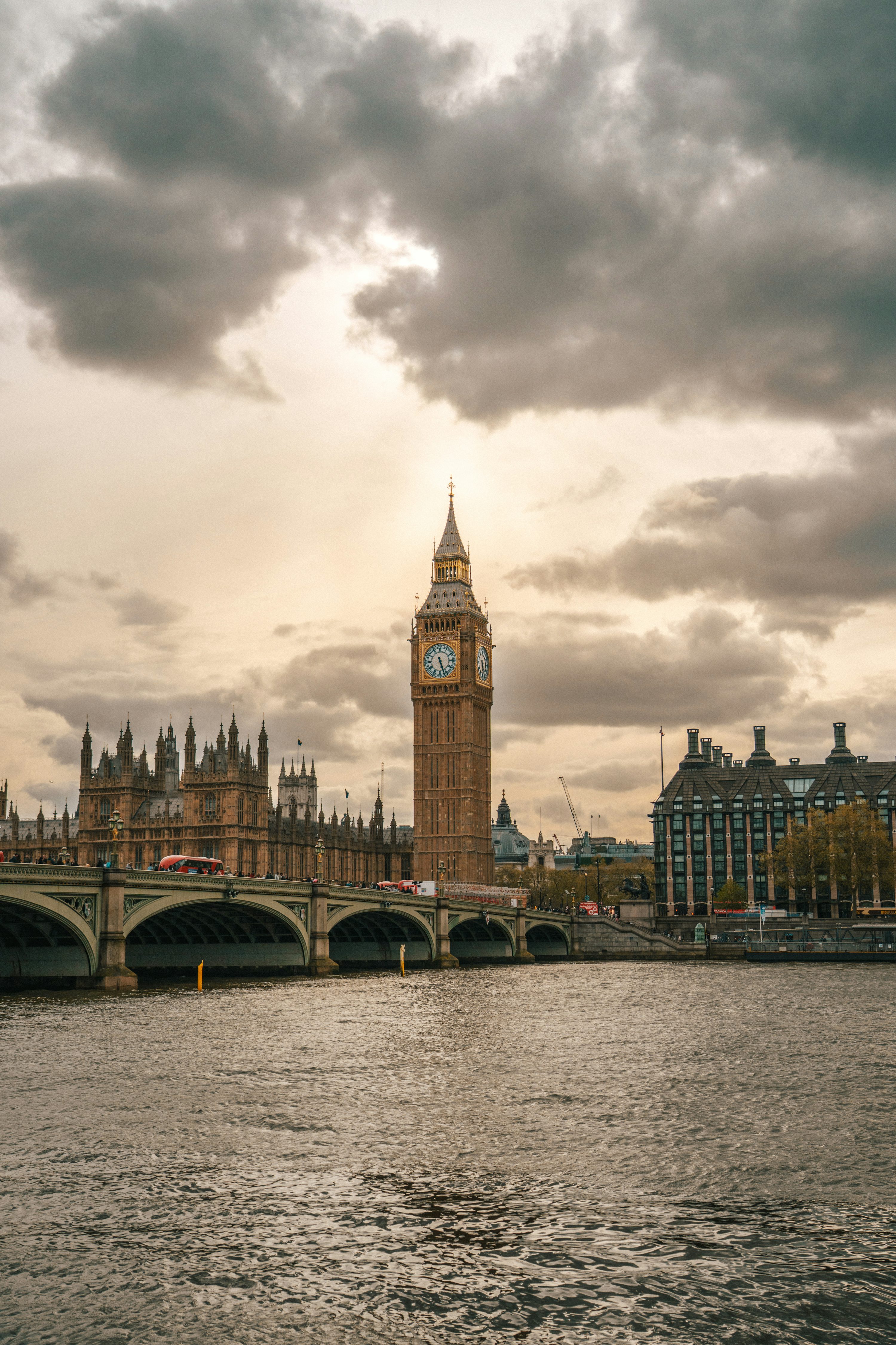 A large clock tower towering over the city of london photo