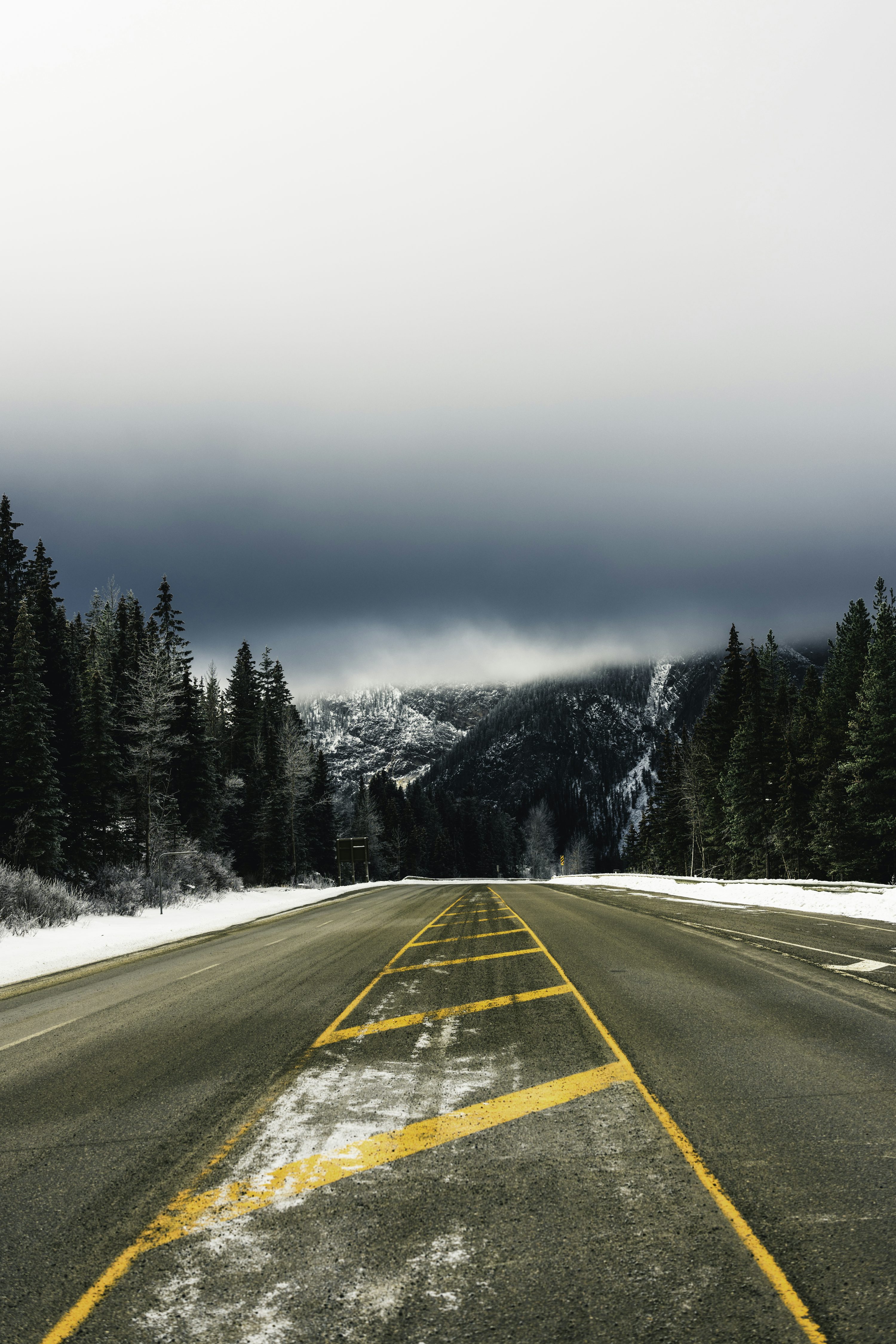 A road with a yellow line painted on the side of it photo