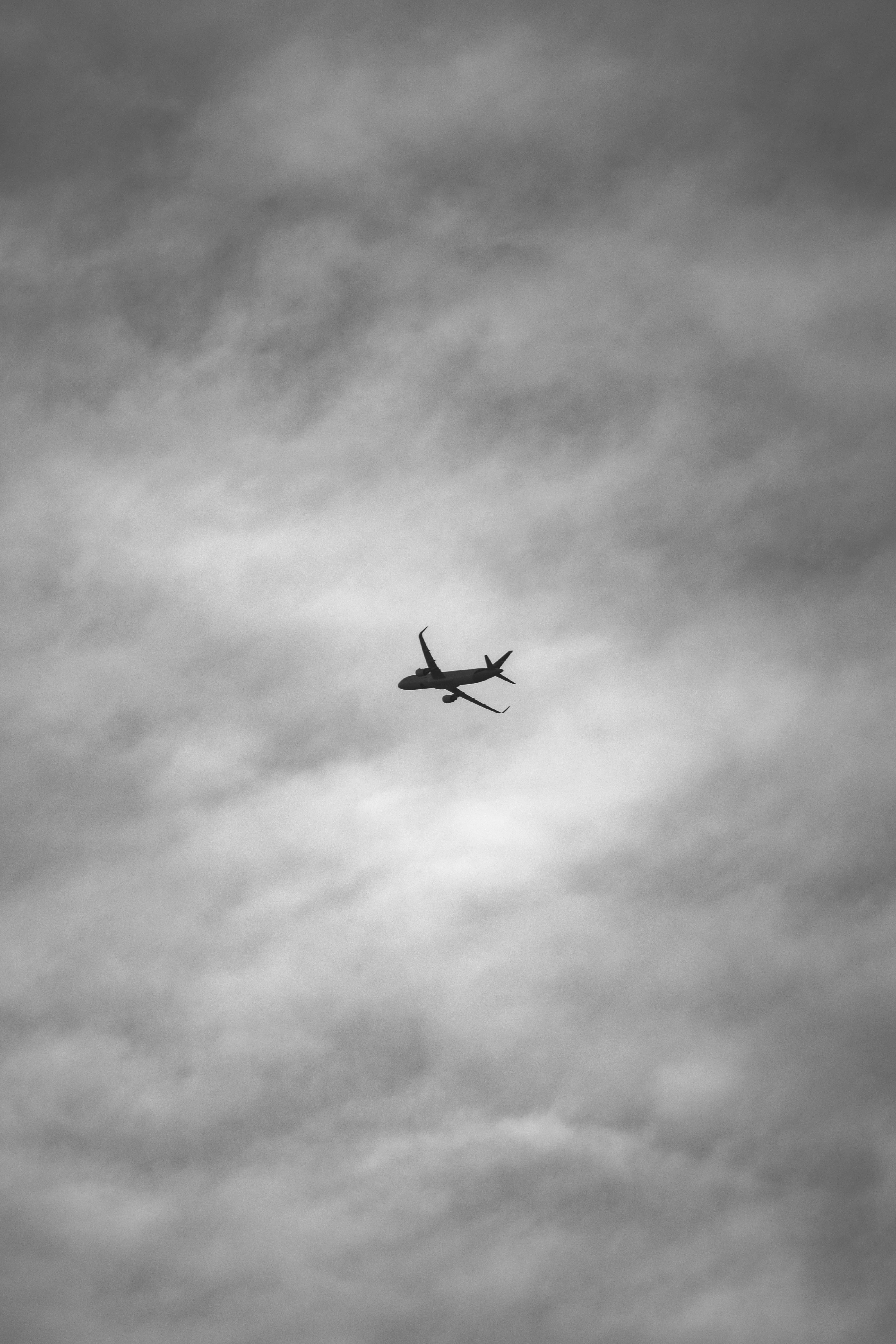 Black and White Photo of Airplane against Cloudy Sky · Free