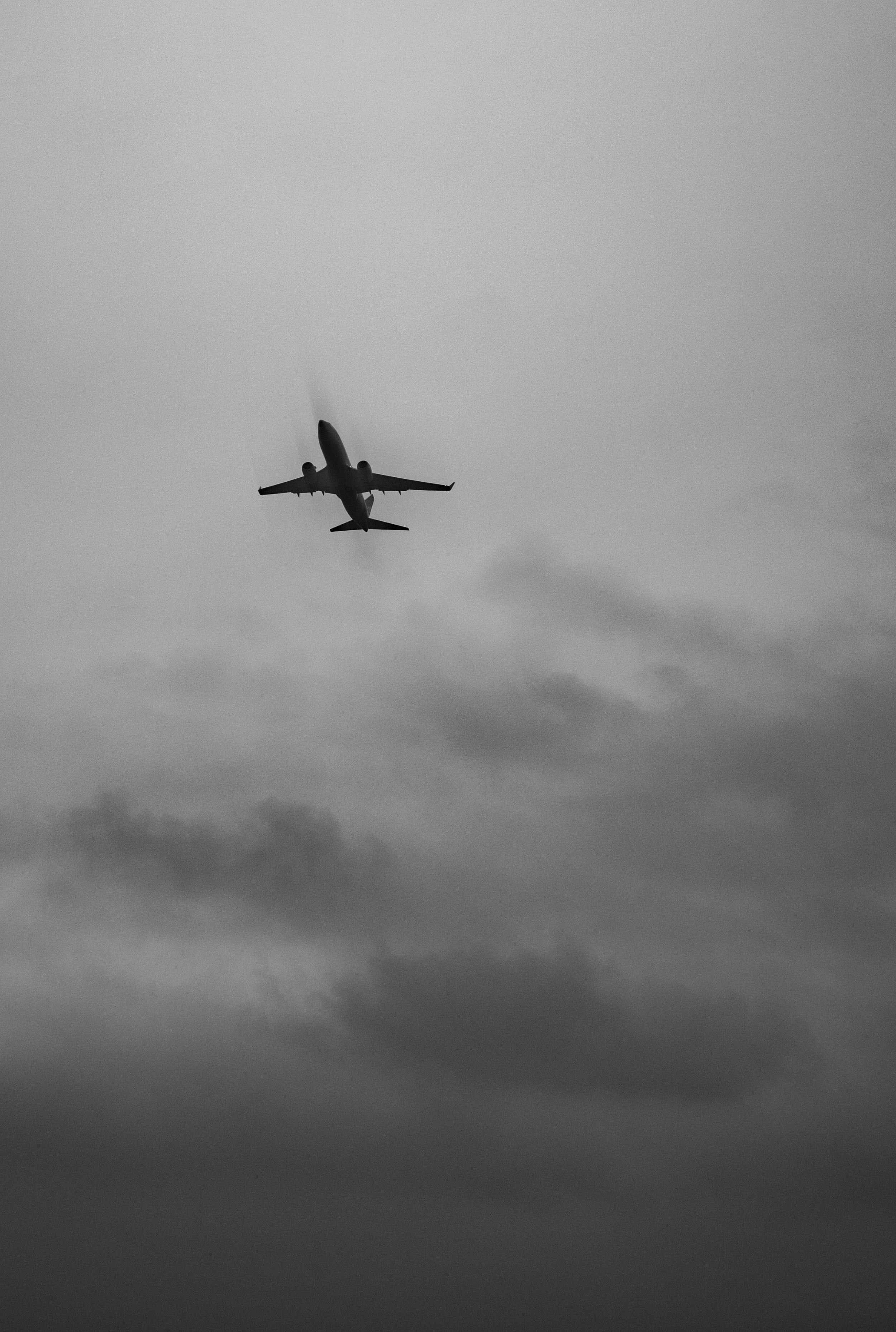 Black and White Photo of Airplane against Cloudy Sky · Free