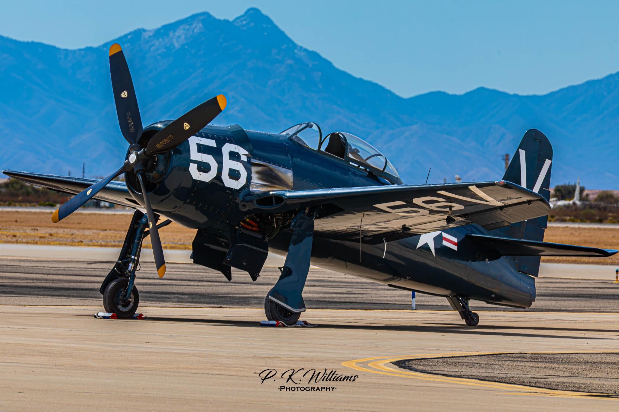 The Grumman Bearcat Standing Proud Against Desert Mountains