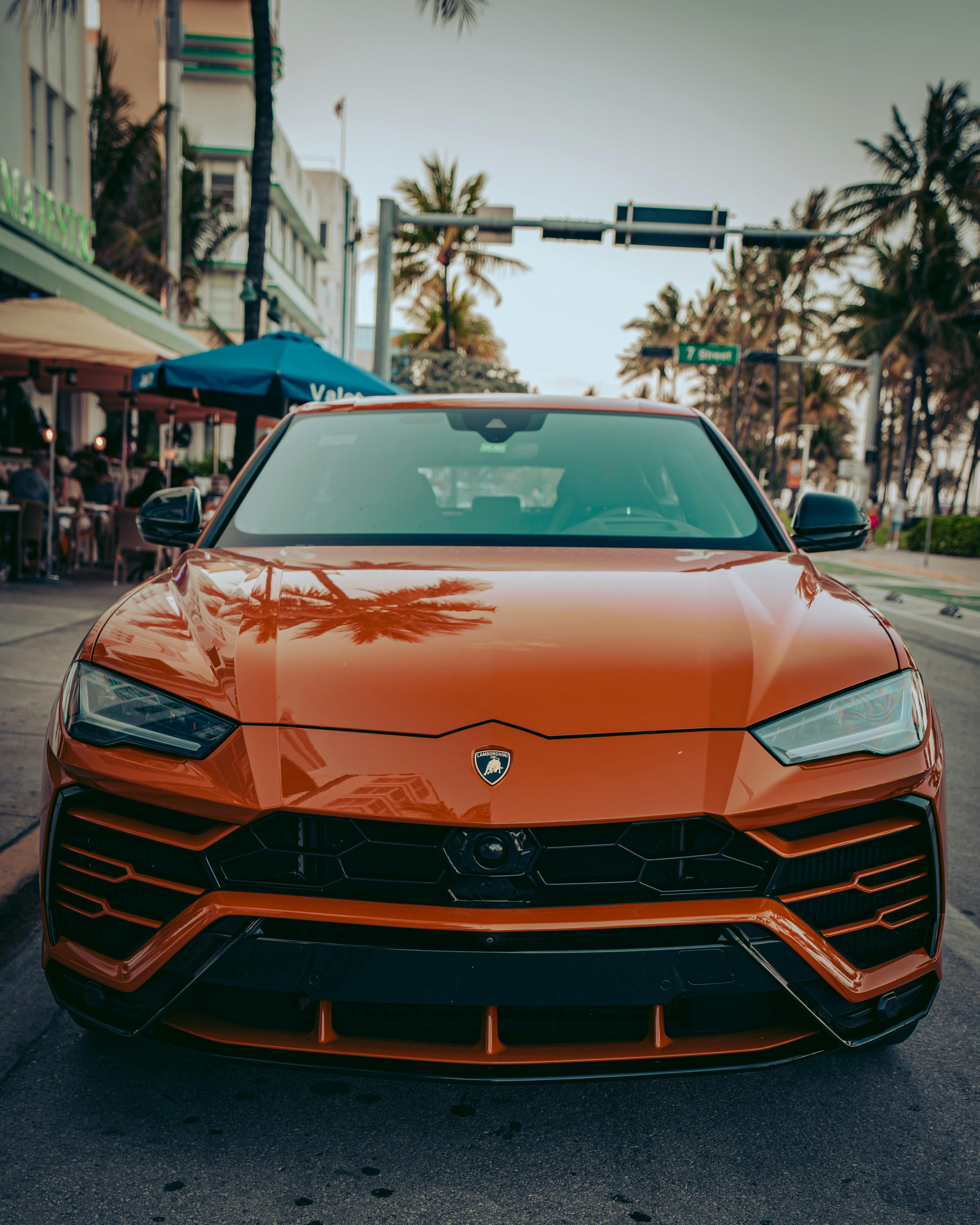 Red Lamborghini Urus Parked On Street Close Up Photo · Free