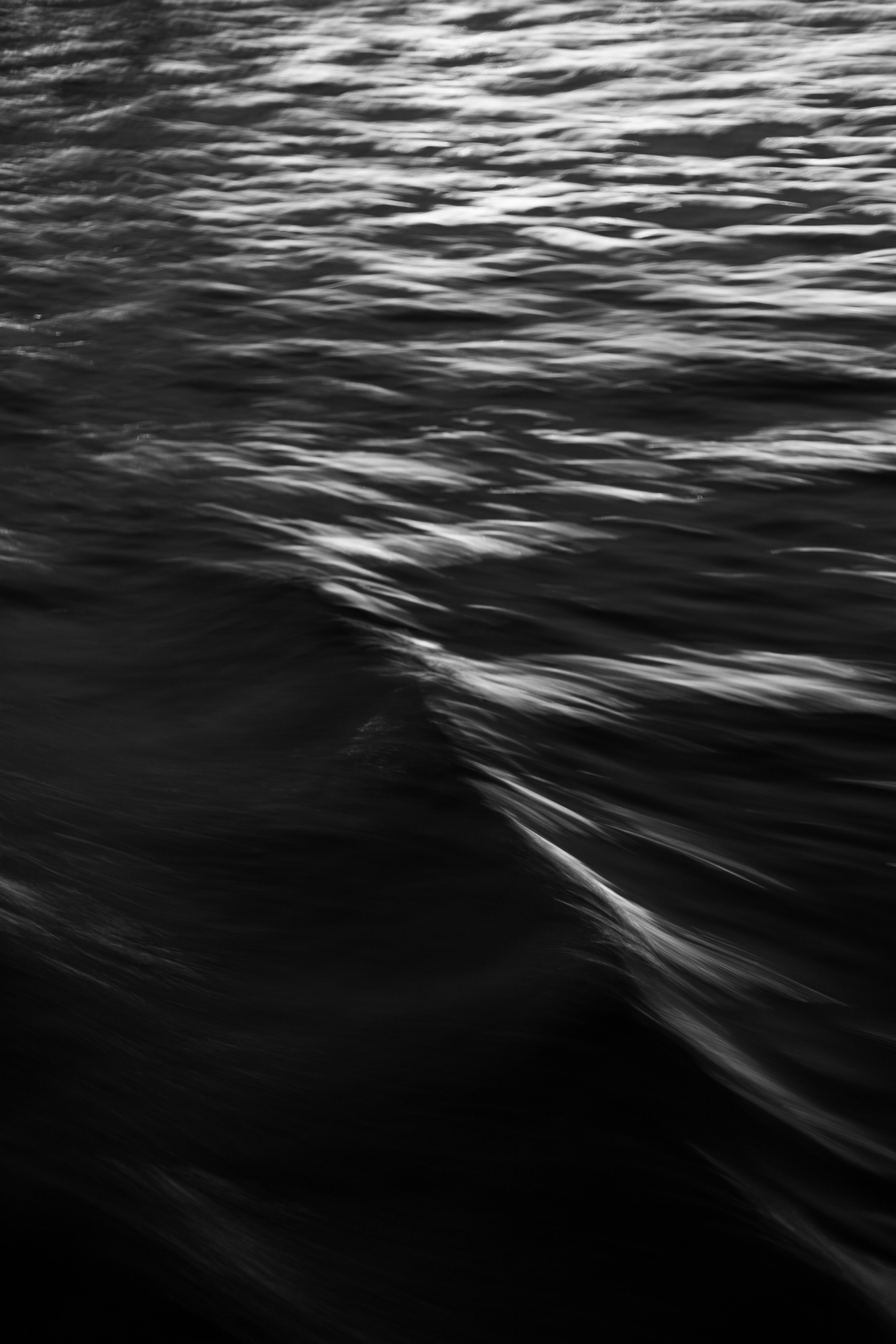 Black and white photograph of water with waves · Free