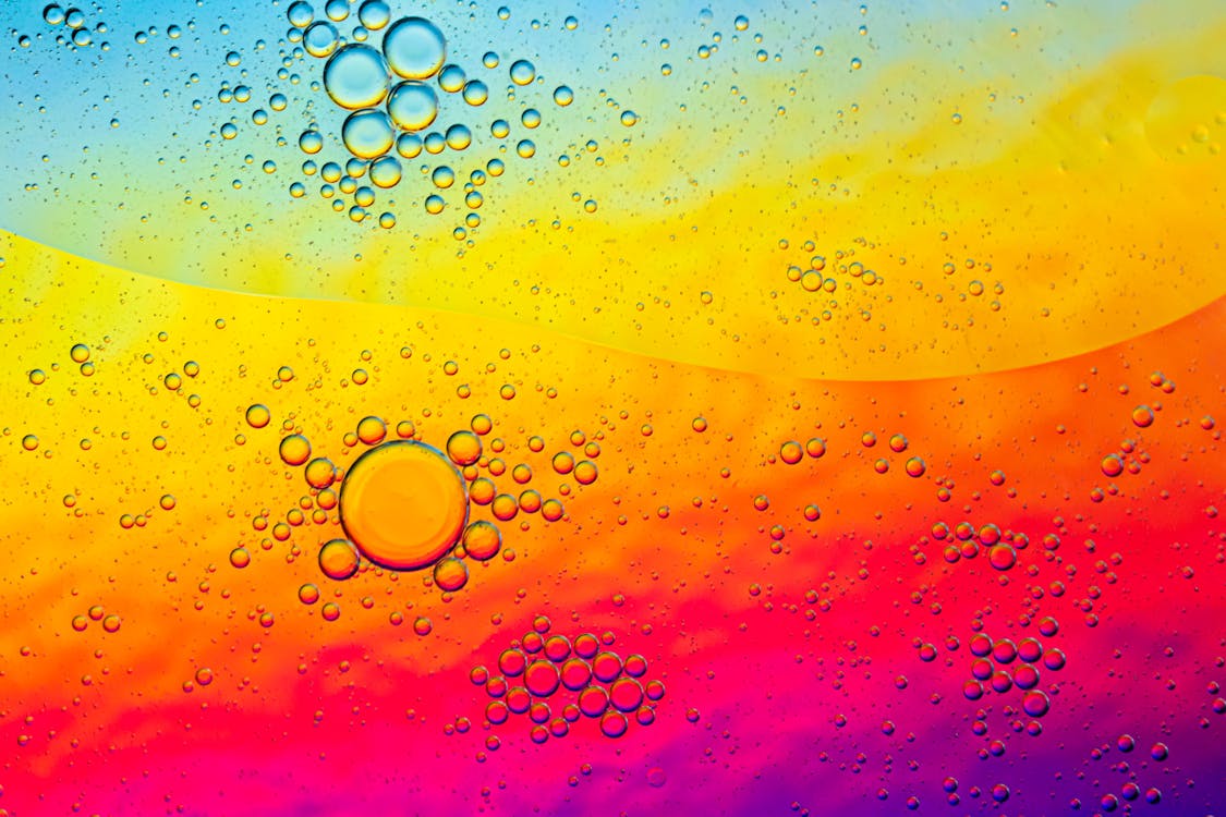 Vibrant Macro of Oil Bubbles on Colorful Surface · Free