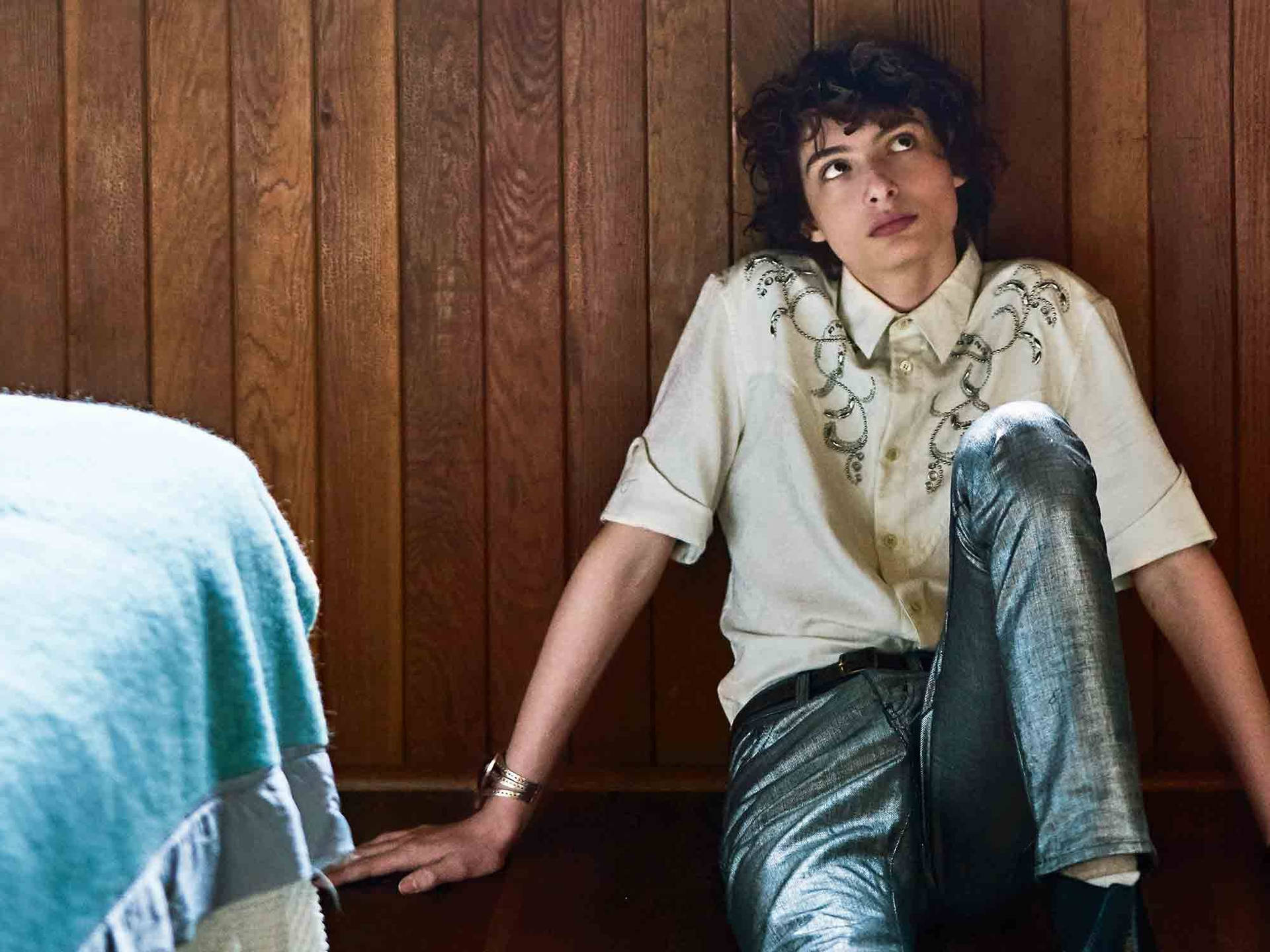 Download Finn Wolfhard On Floor Wallpaper