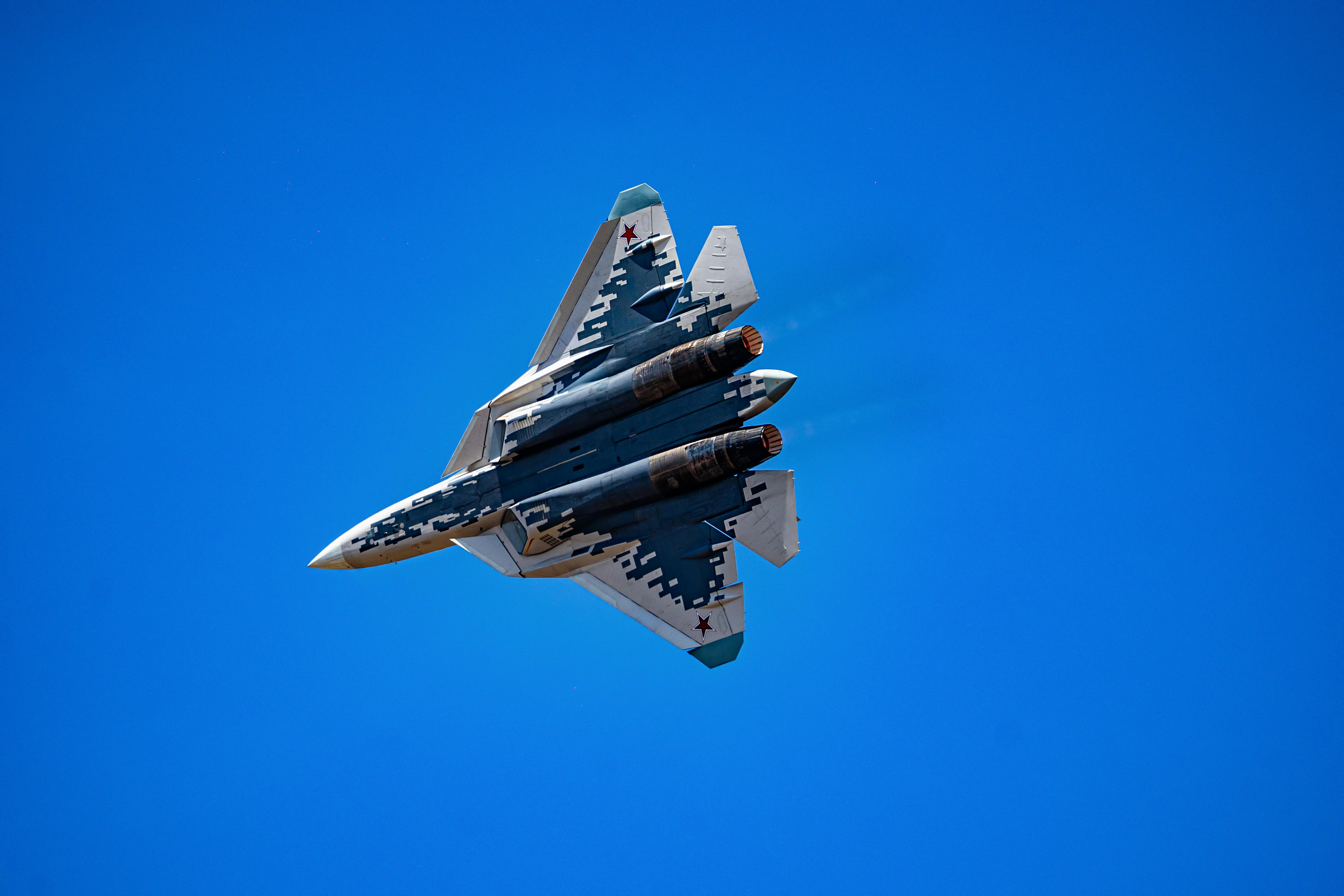 Military Jet Performing Aerial Maneuvers Under Blue Sky · Free