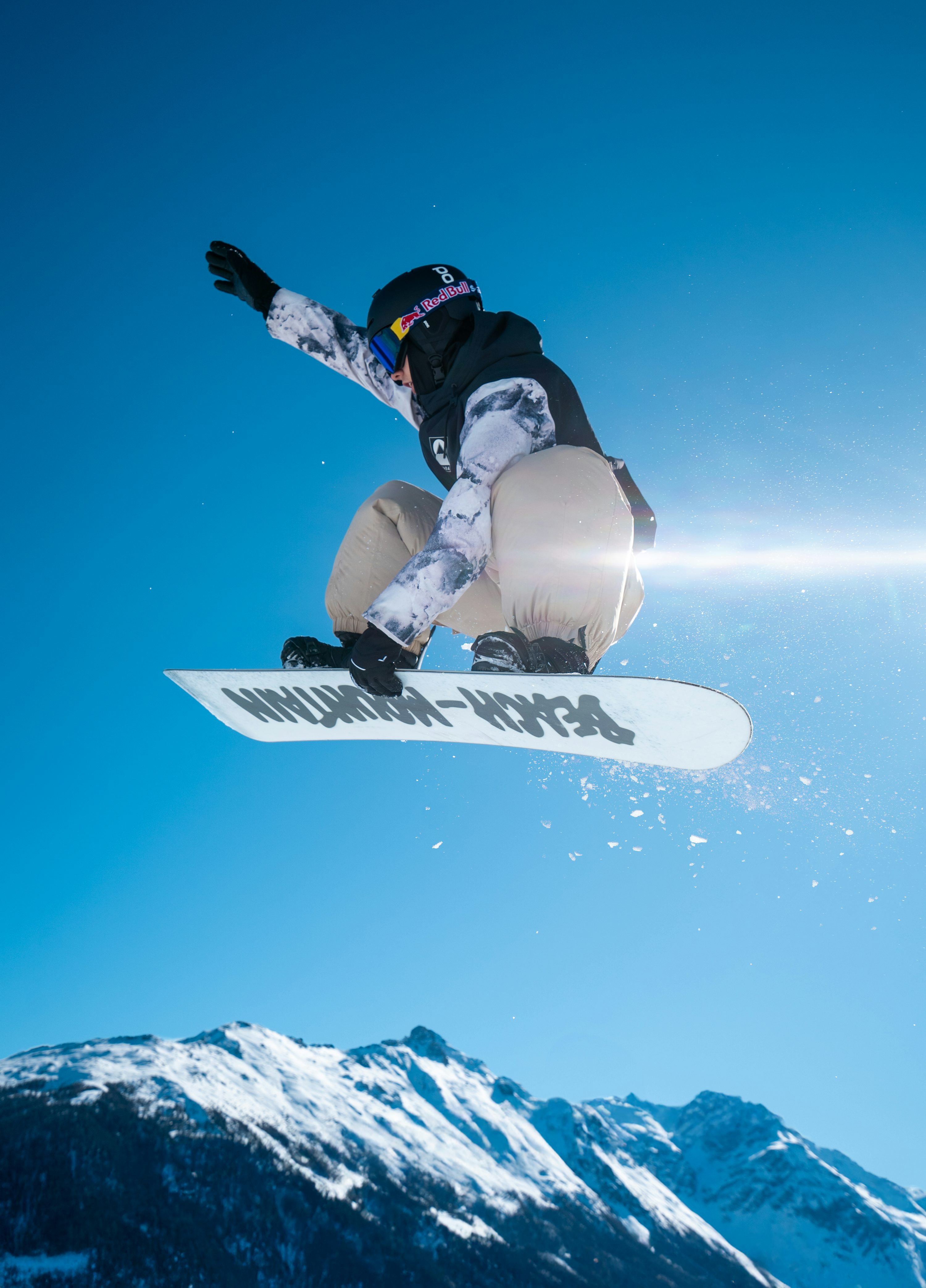 A person on a snowboard jumping in the air photo