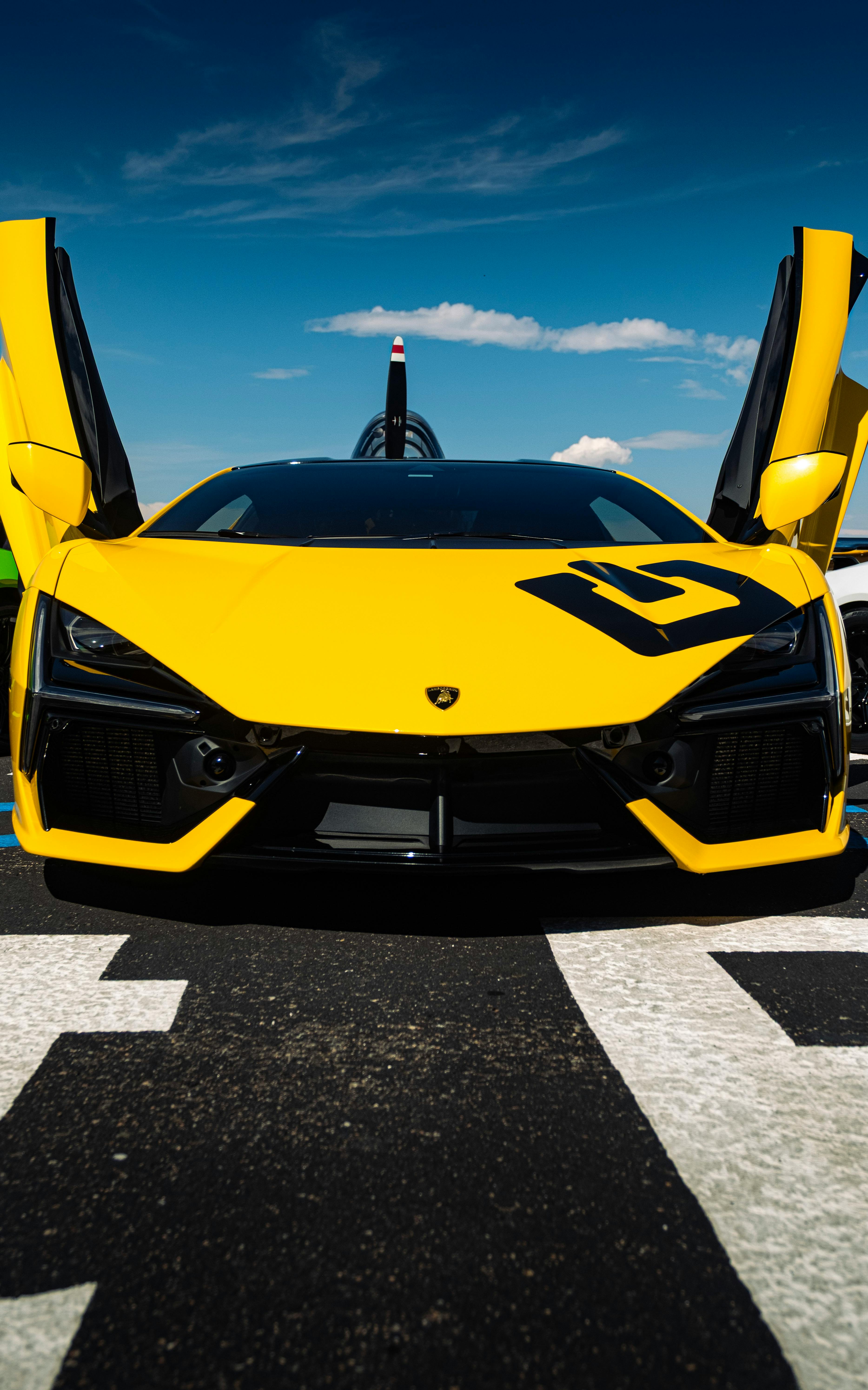 Yellow Lamborghini Revuelto Supercar in Showroom · Free
