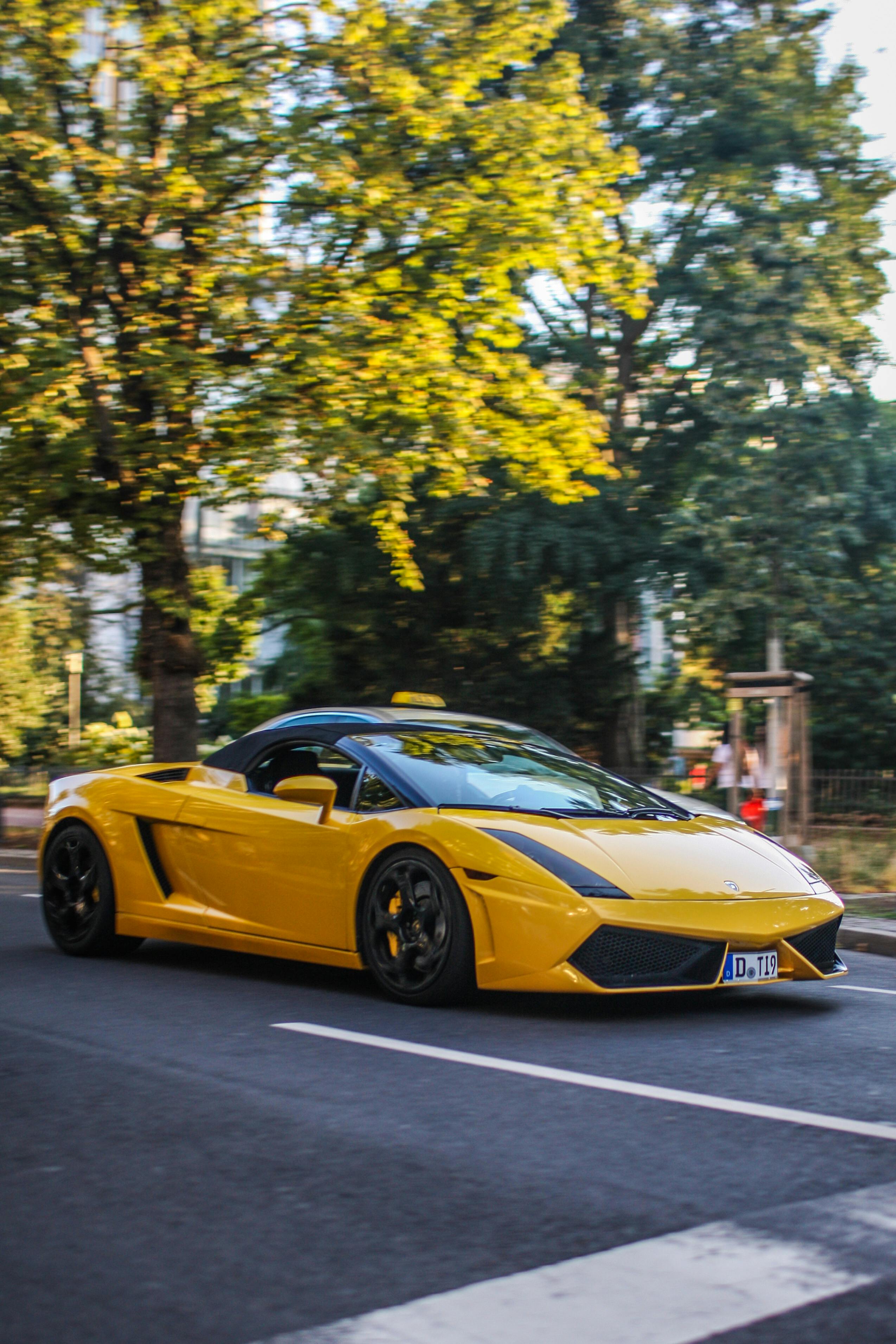 A Yellow Sports Car on the Road · Free
