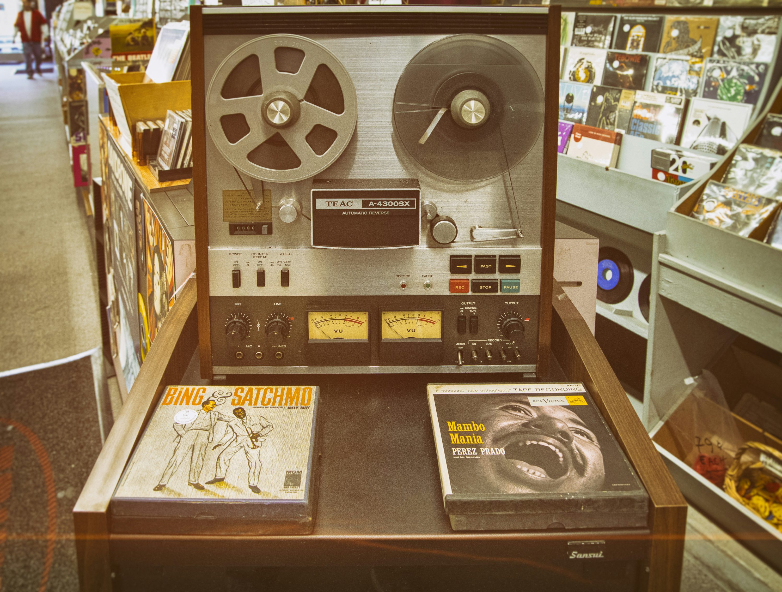 Two albums beside reel player photo