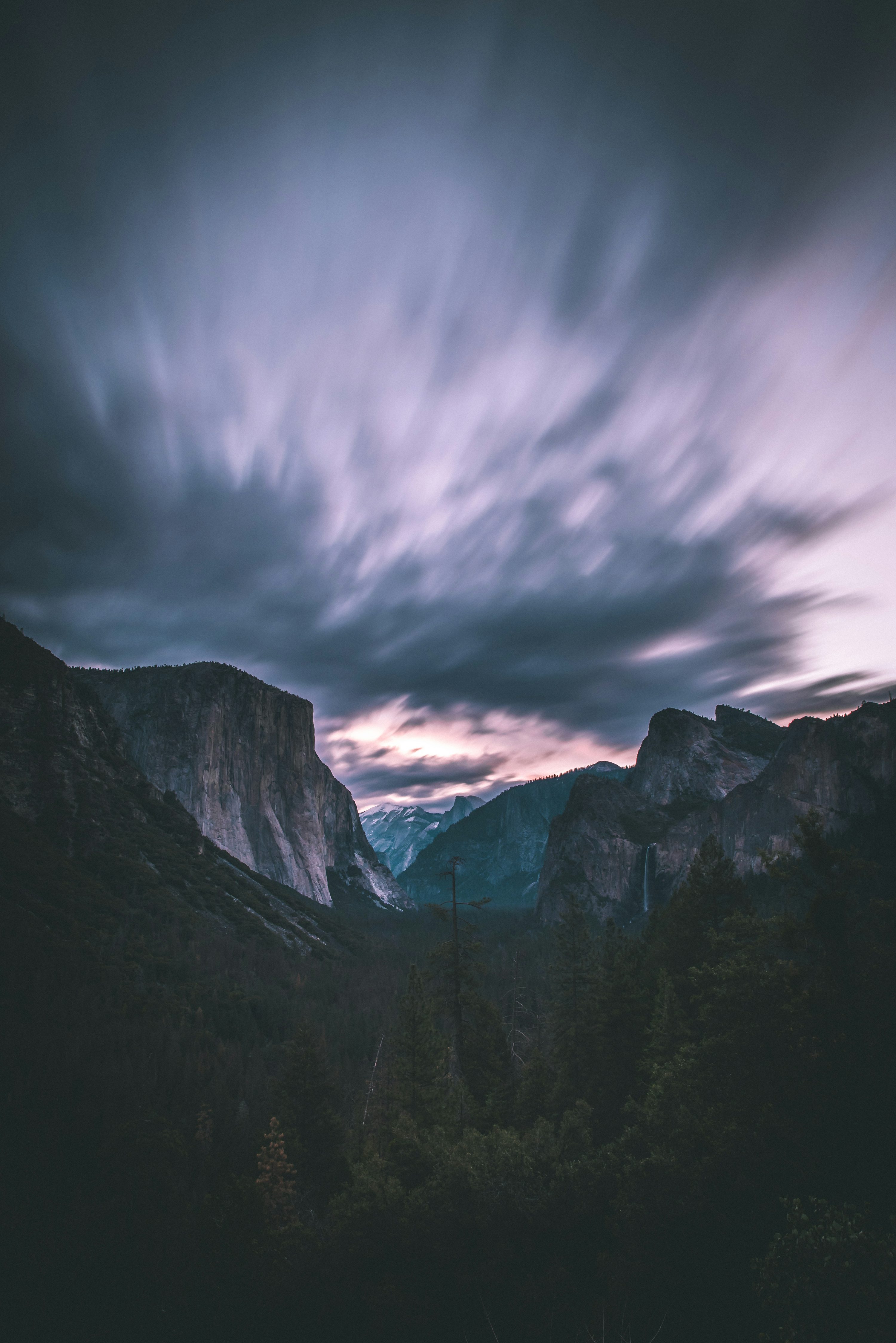 Landscape photo of mountains under cloudy sky photo