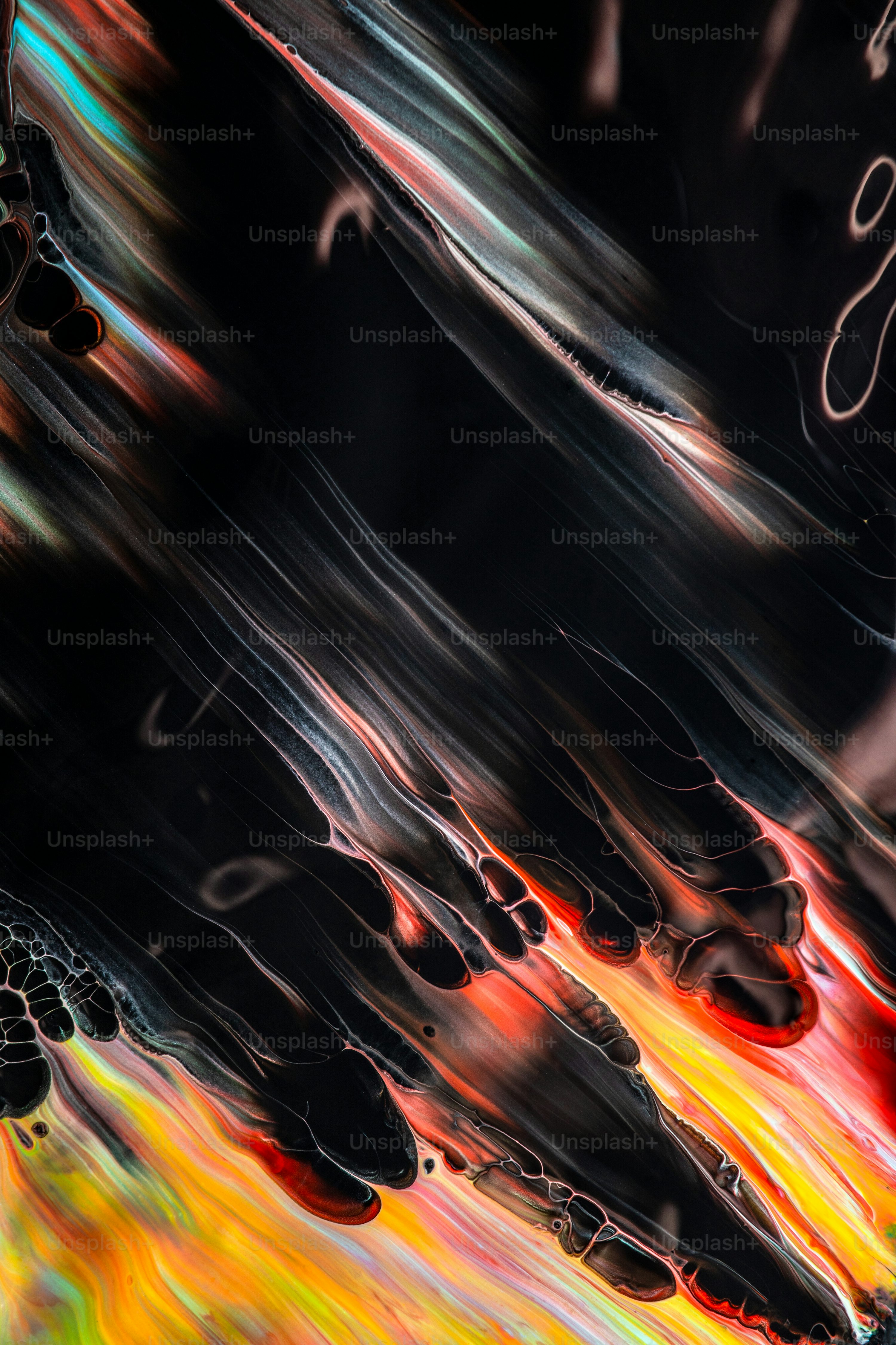 An abstract painting of a black background with orange, yellow, and red colors photo