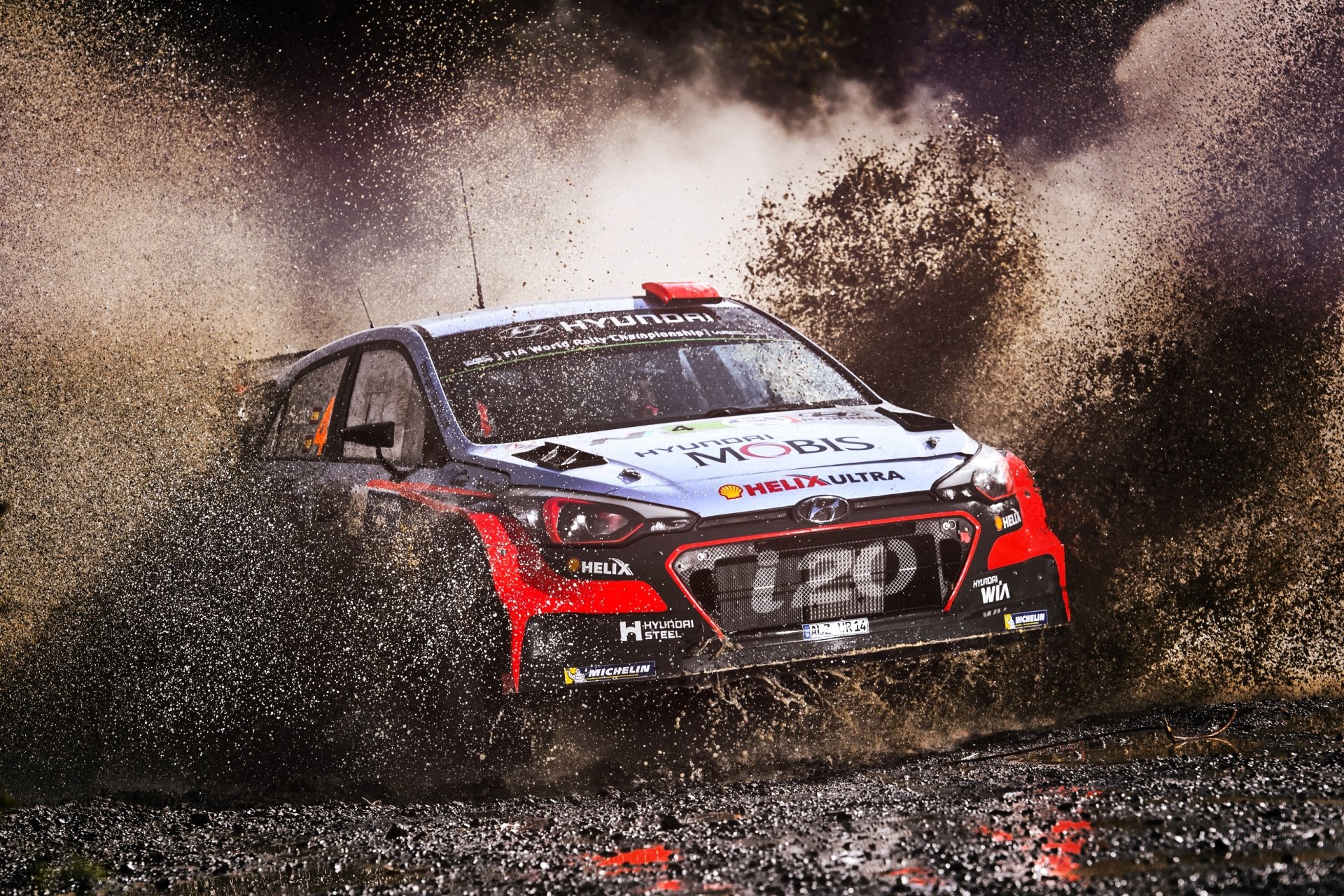 Thrilling Rally Car Racing Through Mud Terrain. HD Sports Wallpaper