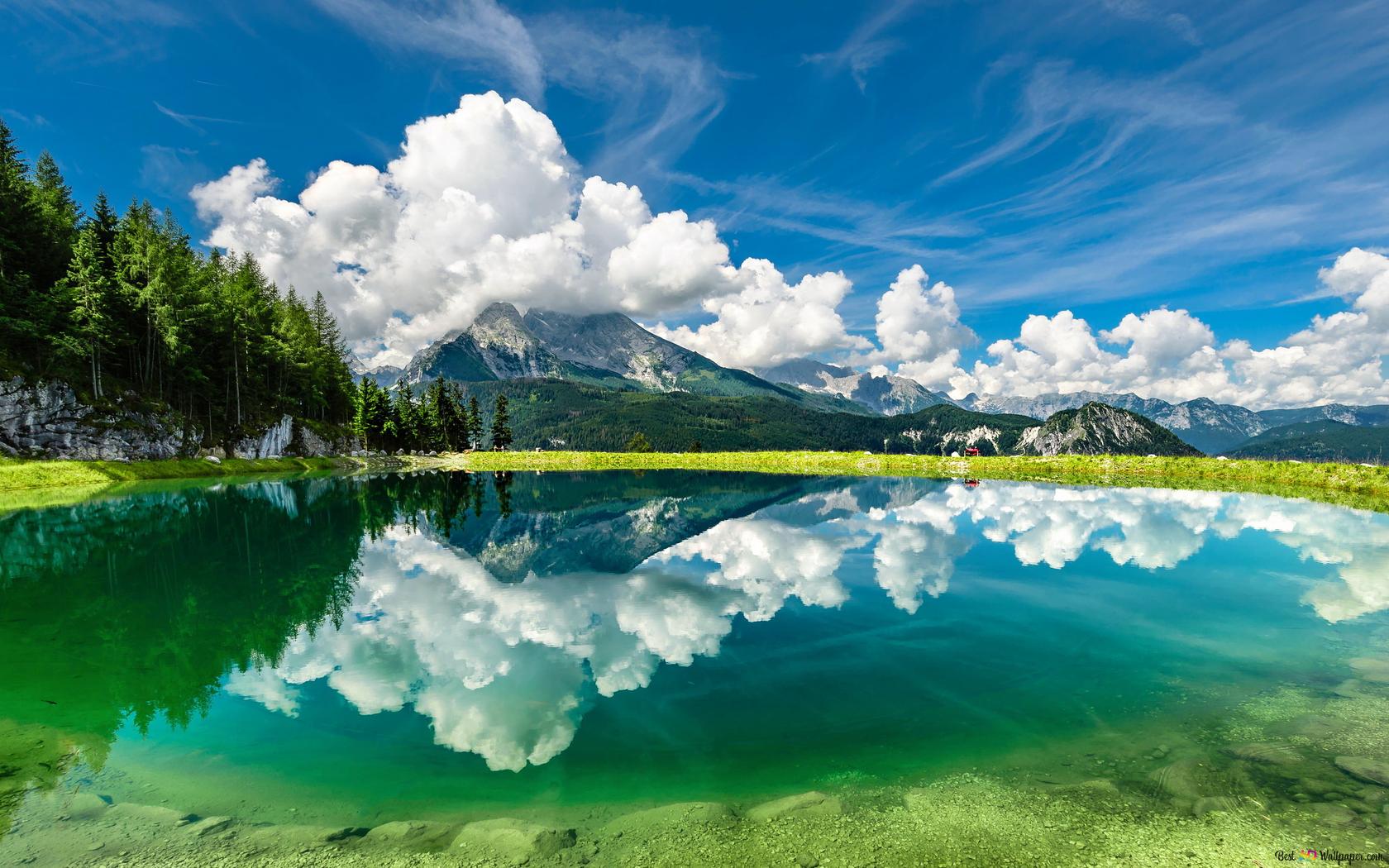 Reflection of forests in green clear water with white clouds gathered 2K wallpaper download