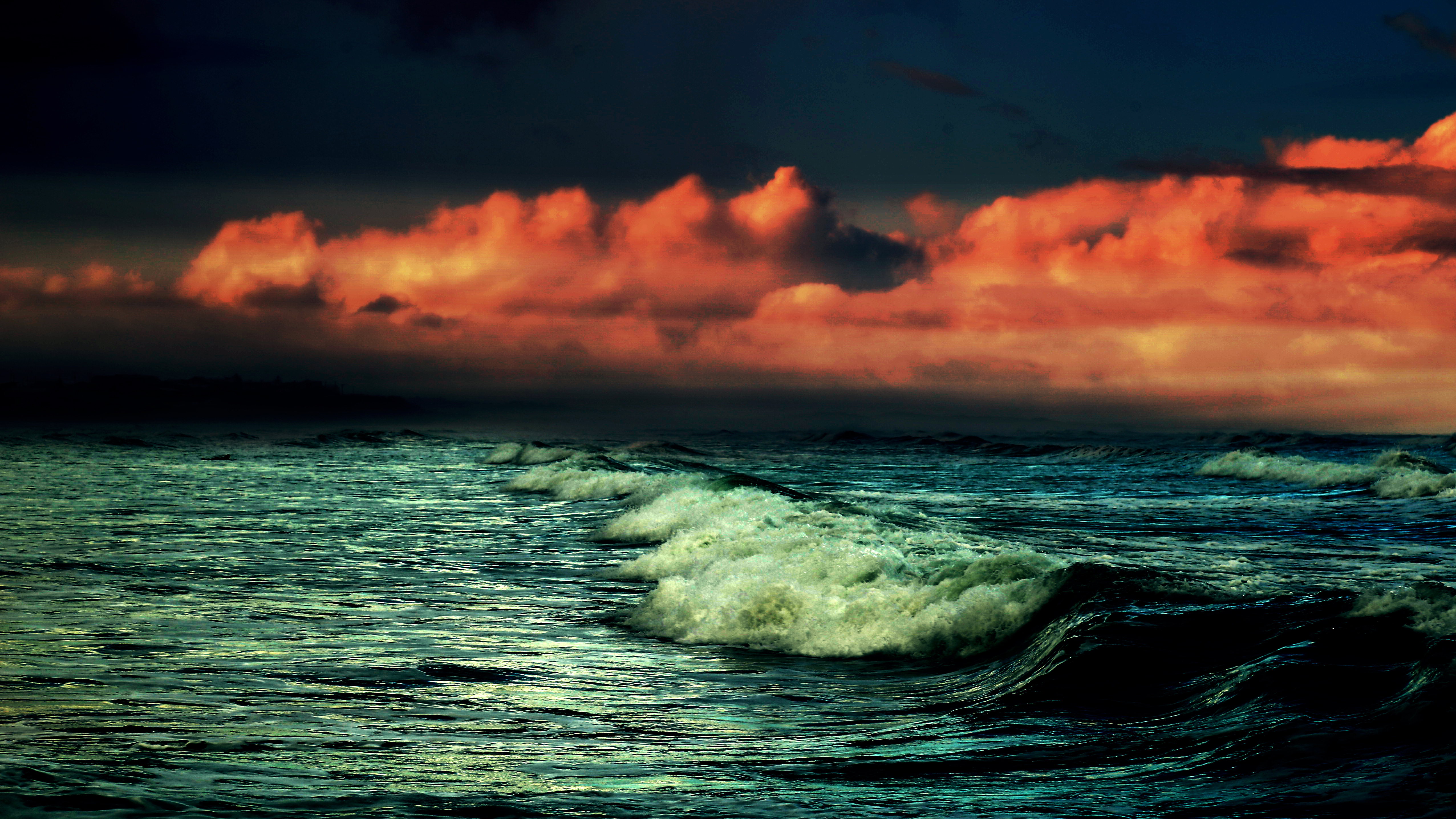 Dark waves under red clouds