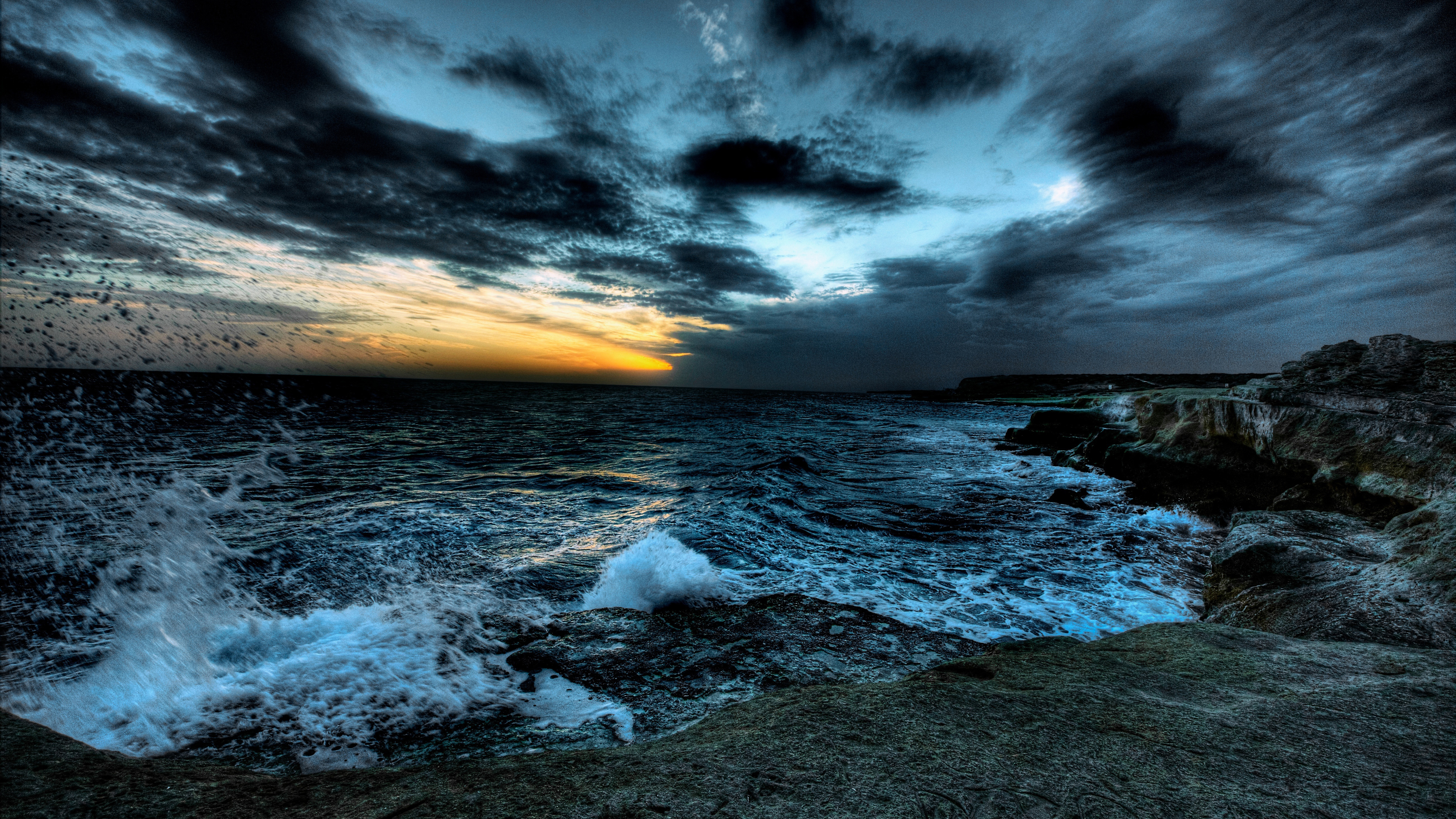 rough sea under dark clouds sky rocks ocean waves splash during sunset 4K 5K HD Nature Wallpaper