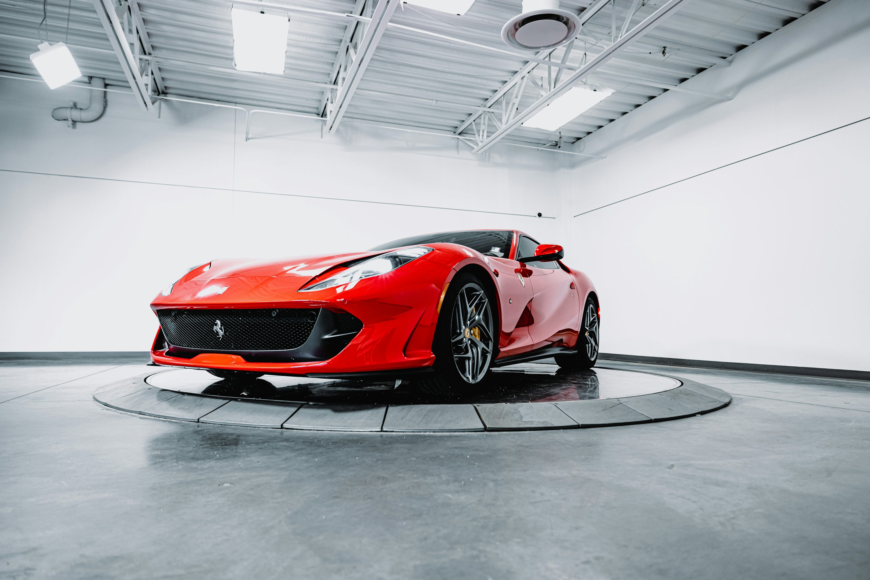 A red sports car parked in a garage photo