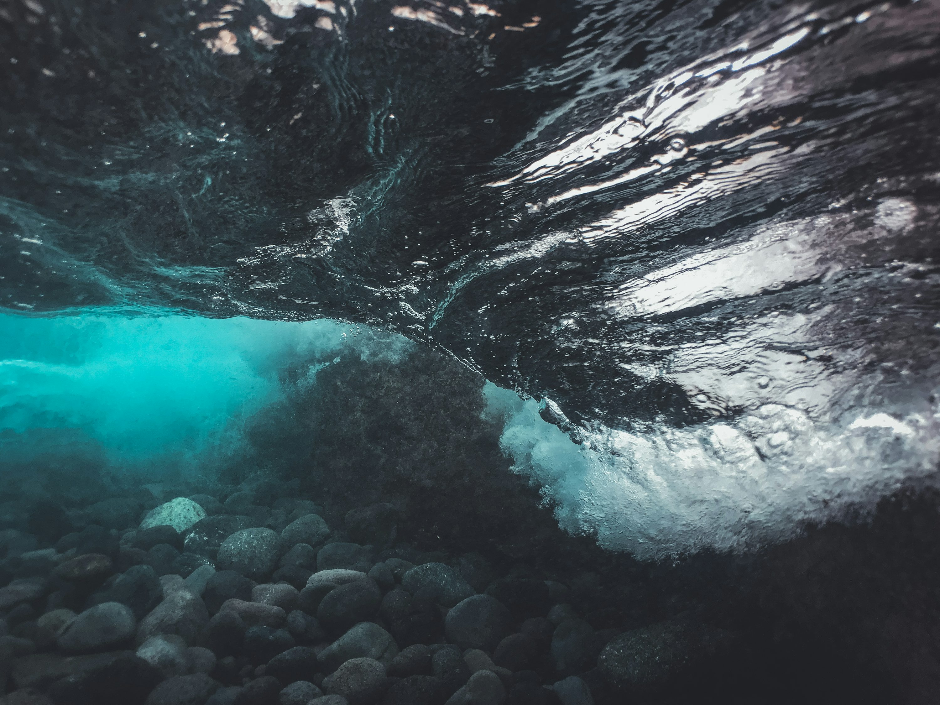 An underwater view of rocks and water photo