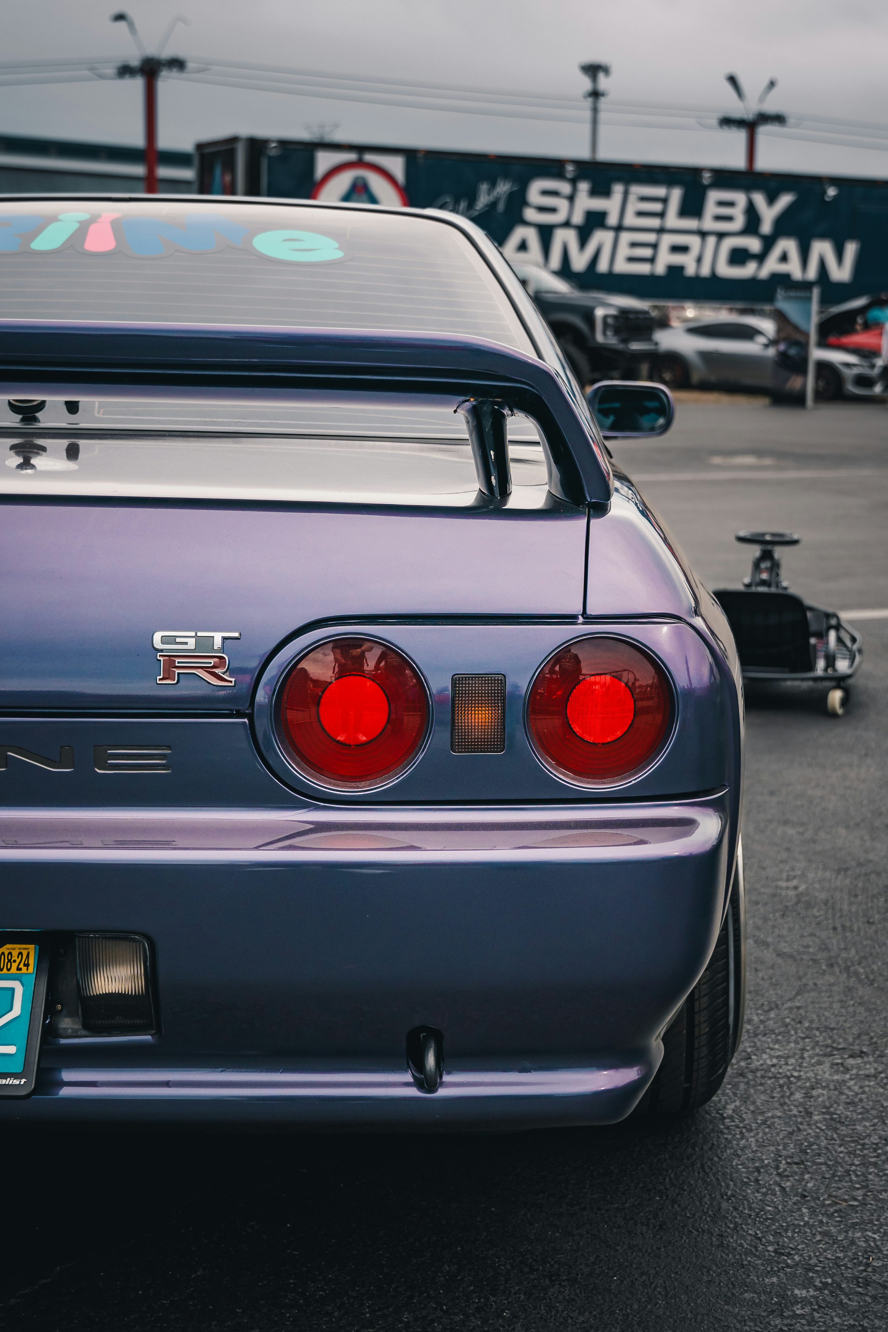 A Purple Nissan Skyline Gt R Is Parked. Photo