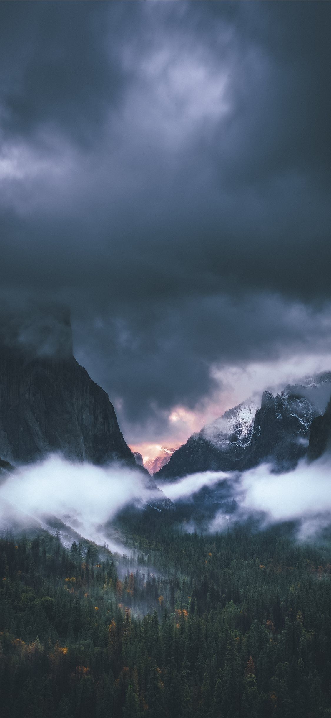 brown rocky mountain under gray sky iPhone 11 Wallpaper