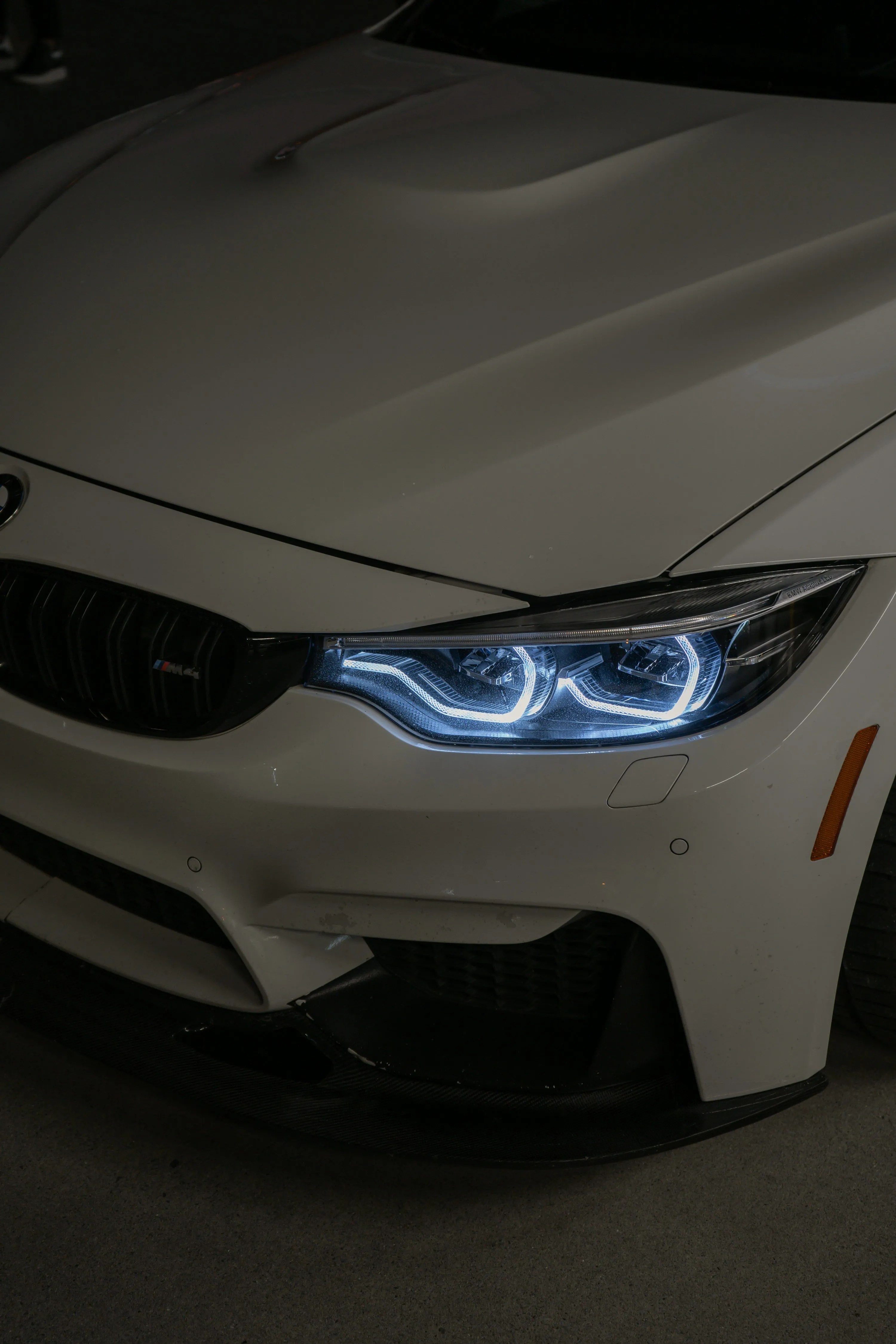 A white car with a blue light on it's headlight photo