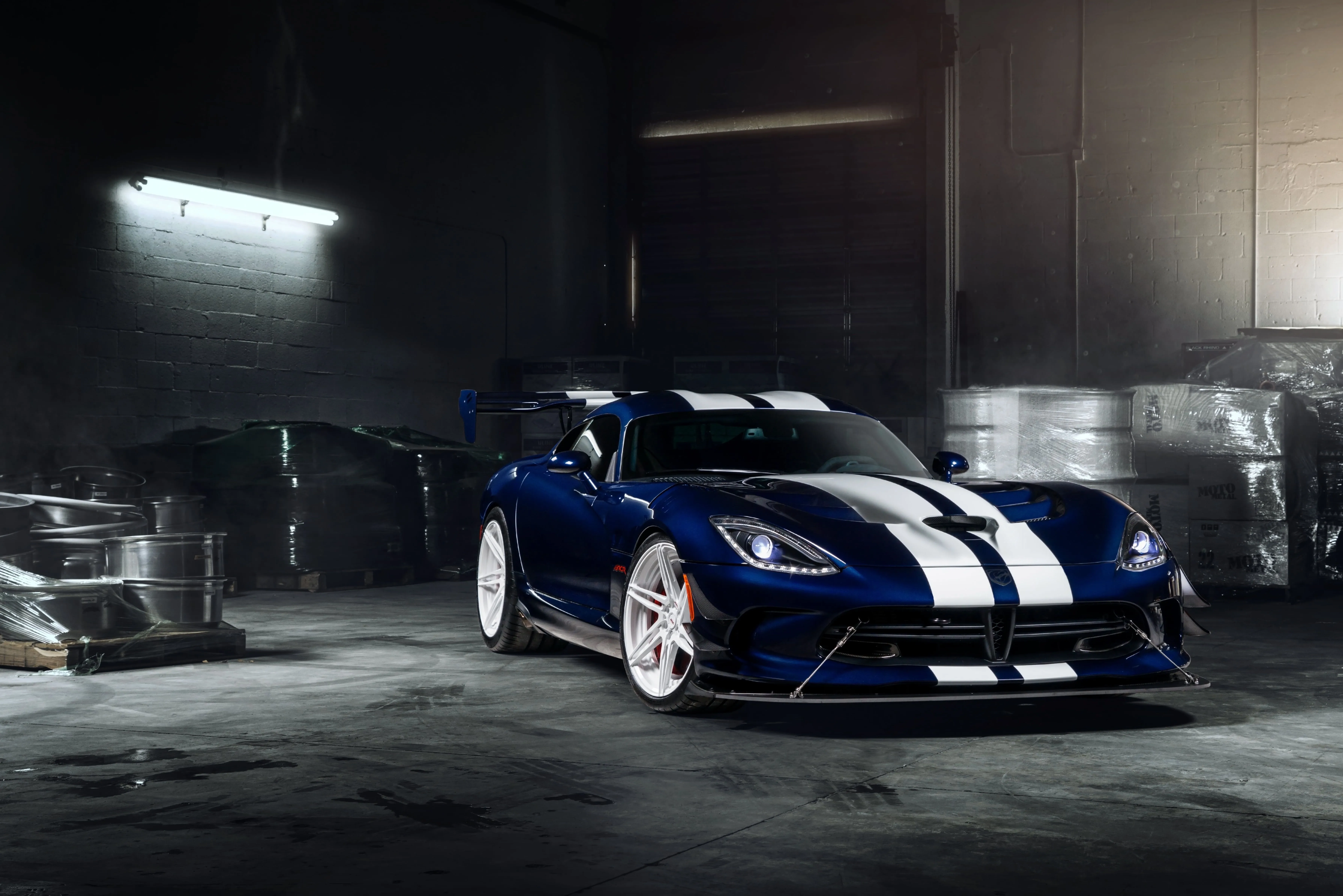 Blue and white car surrounded by barrels HD wallpaper