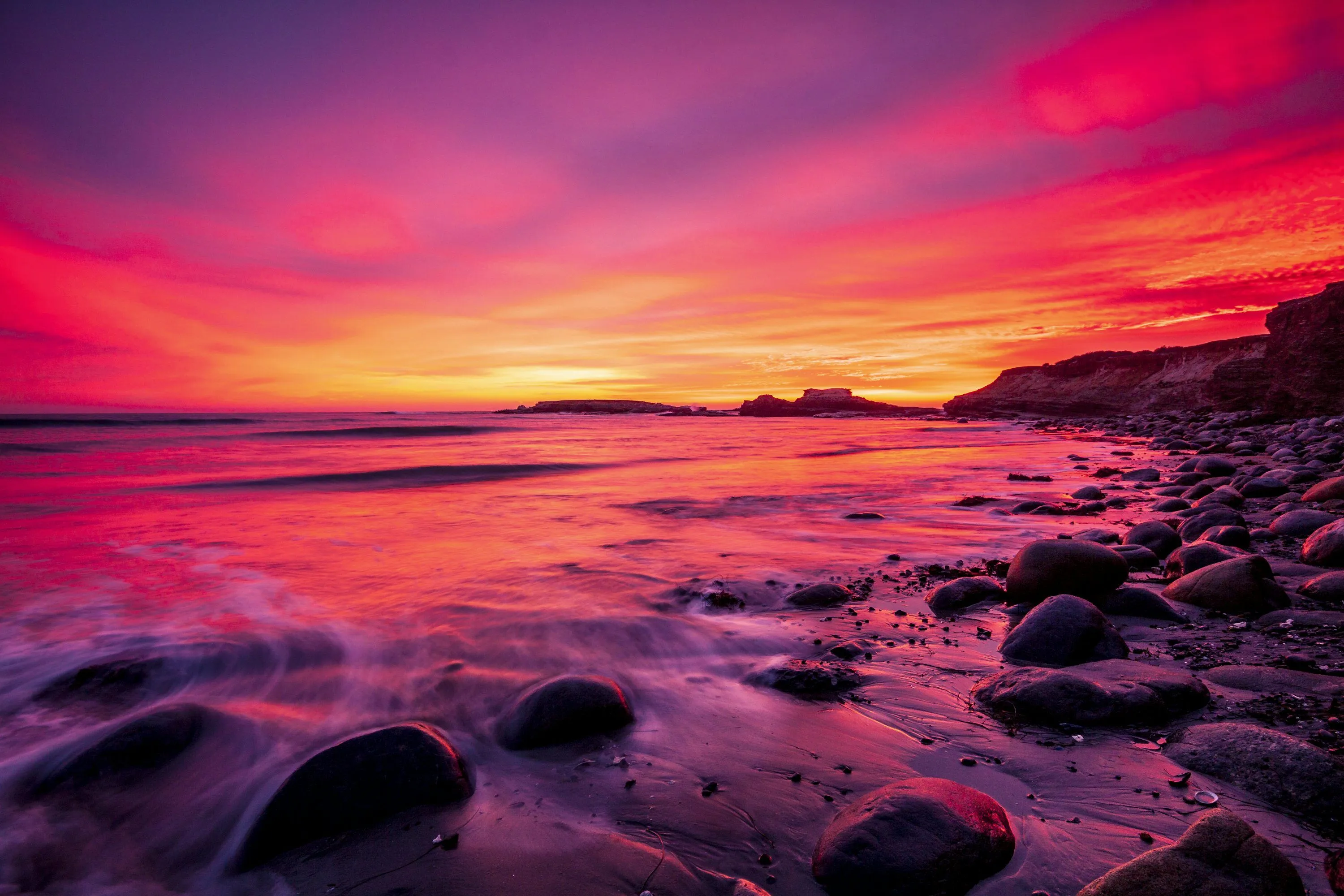 Rocky shore during sunset with red sky photo