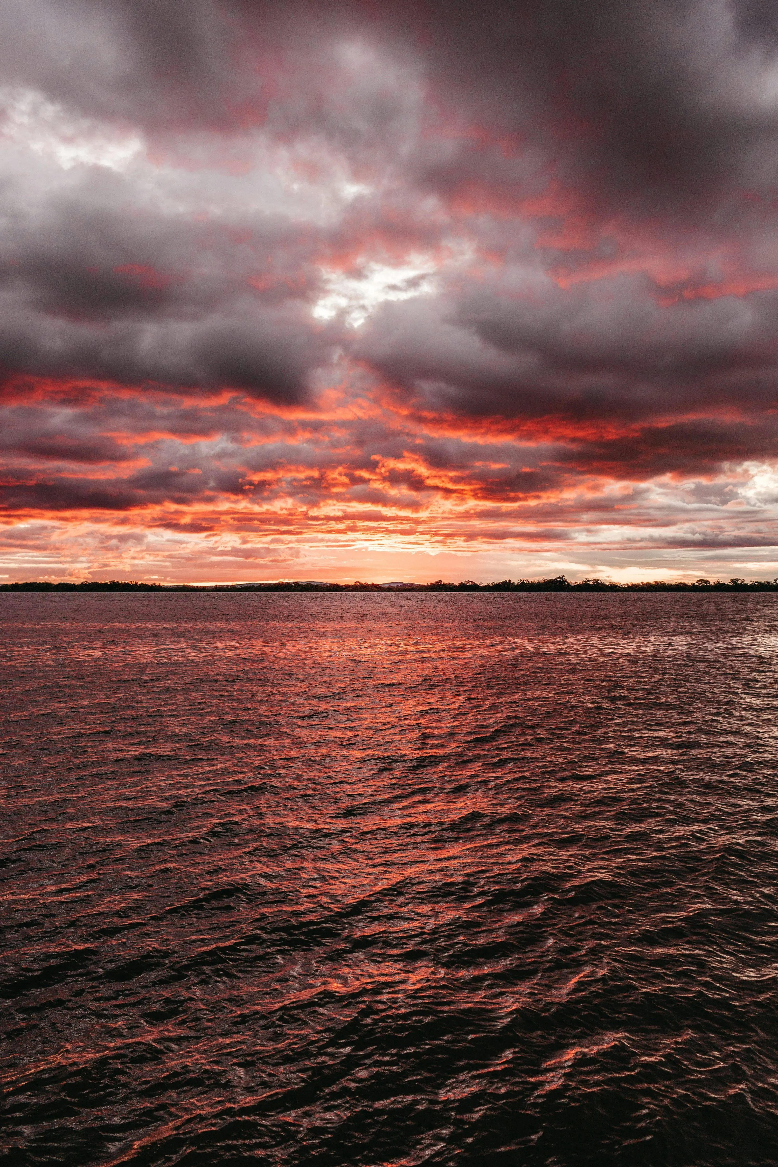 Sea under gray and red sky photo