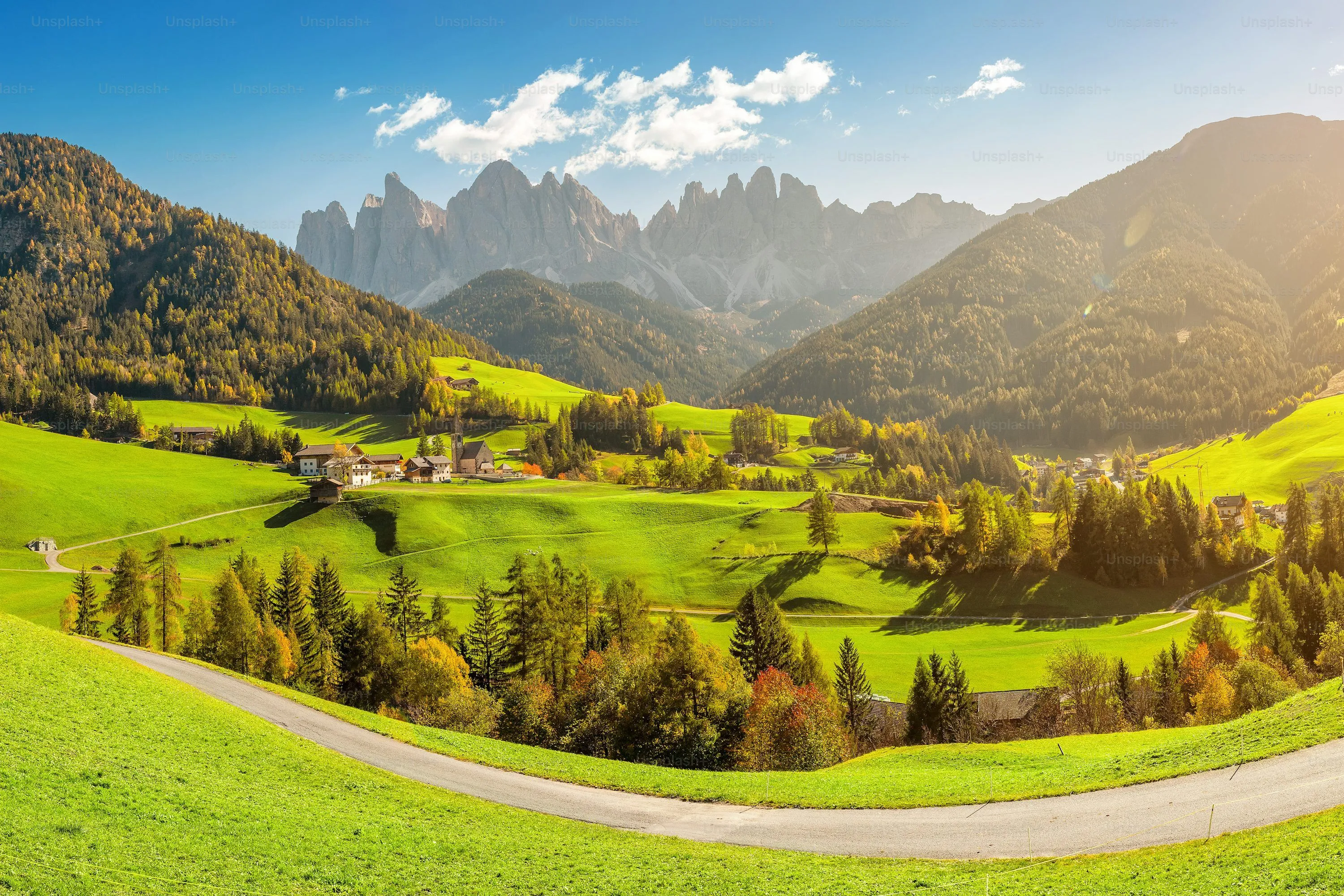 Famous travel destination in Italian Dolomites Funes valley. Val Di Funes and Santa Magdalena village during autumn with rocky Alps at the background photo