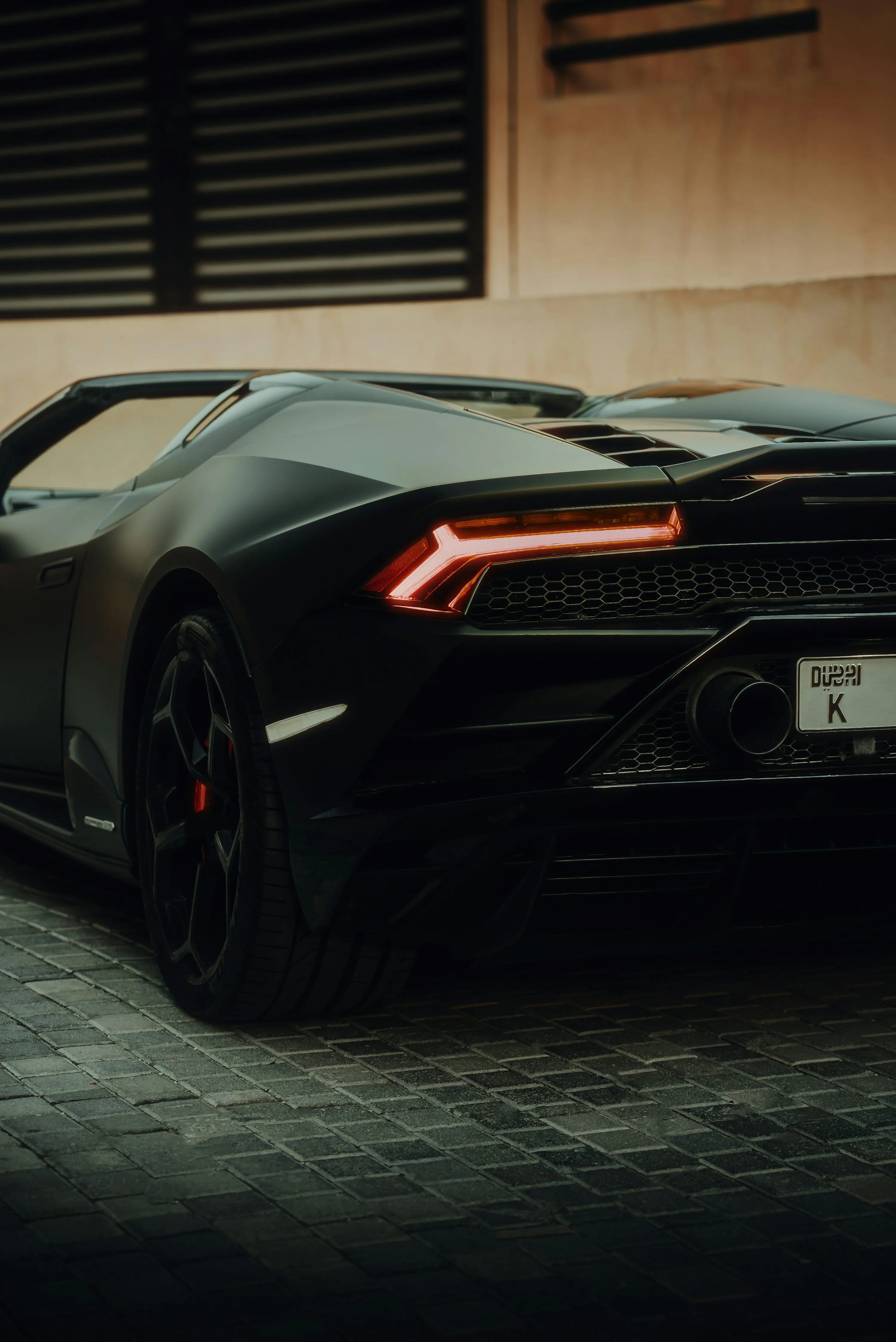 A black lamborghini parked on the street. photo