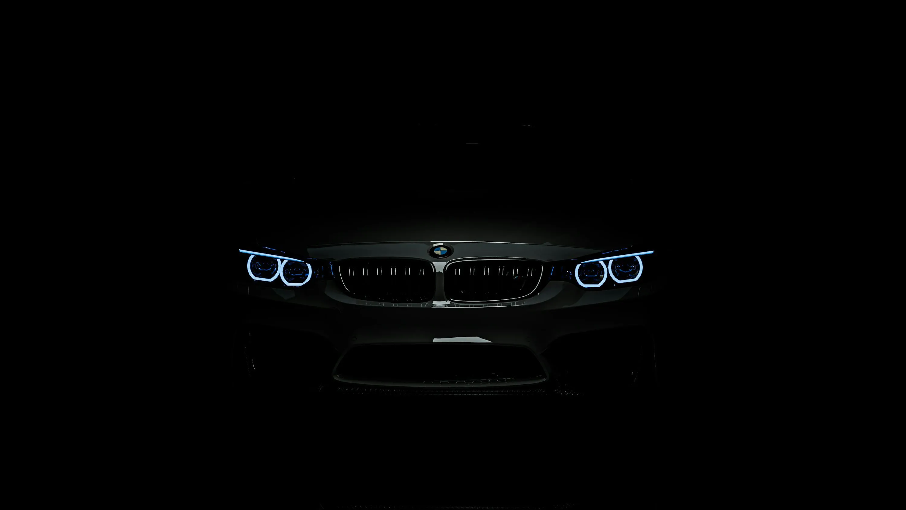 The front lights of a car in the dark photo