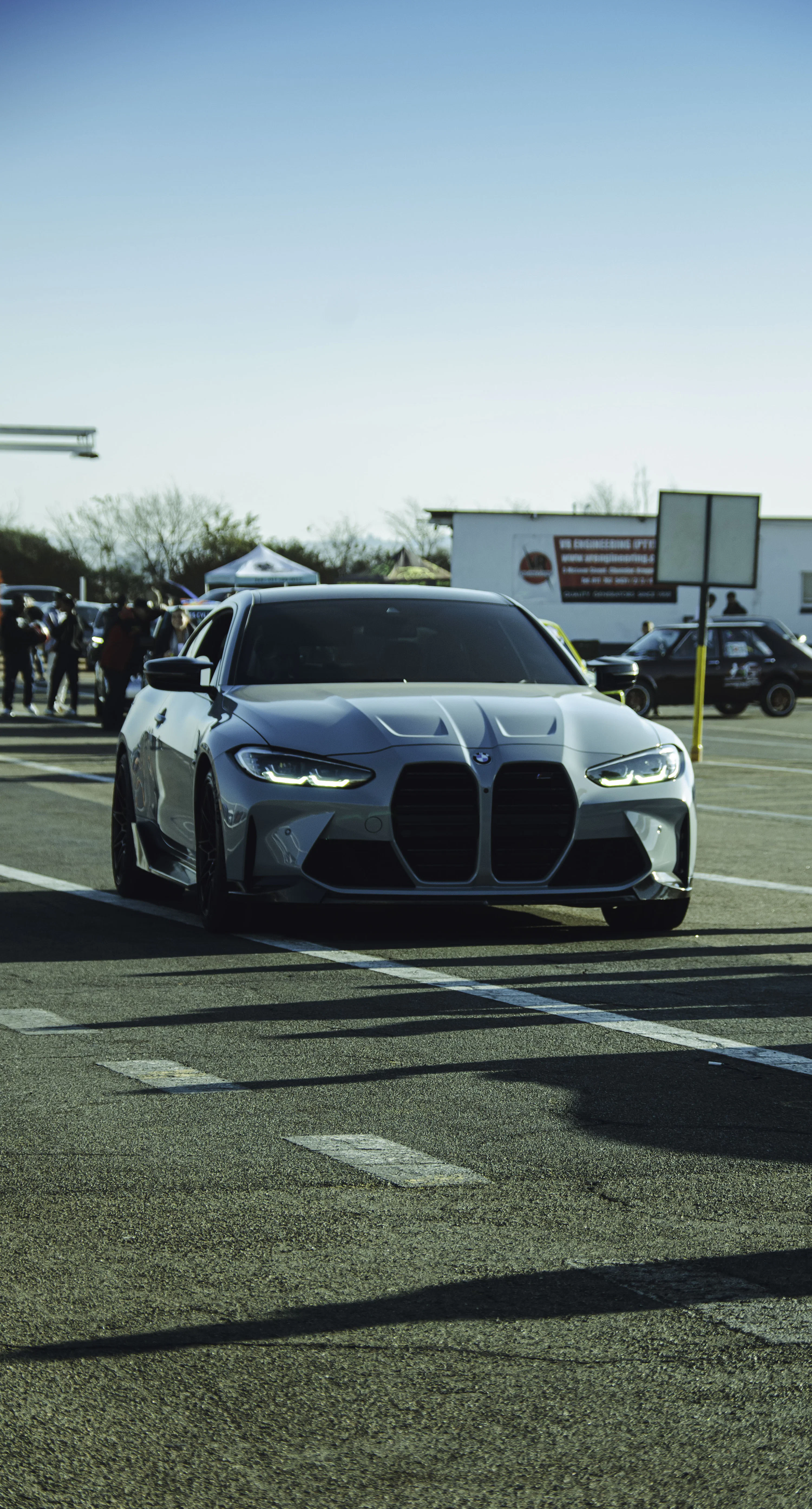 A blue BMW car is driving on the road. photo