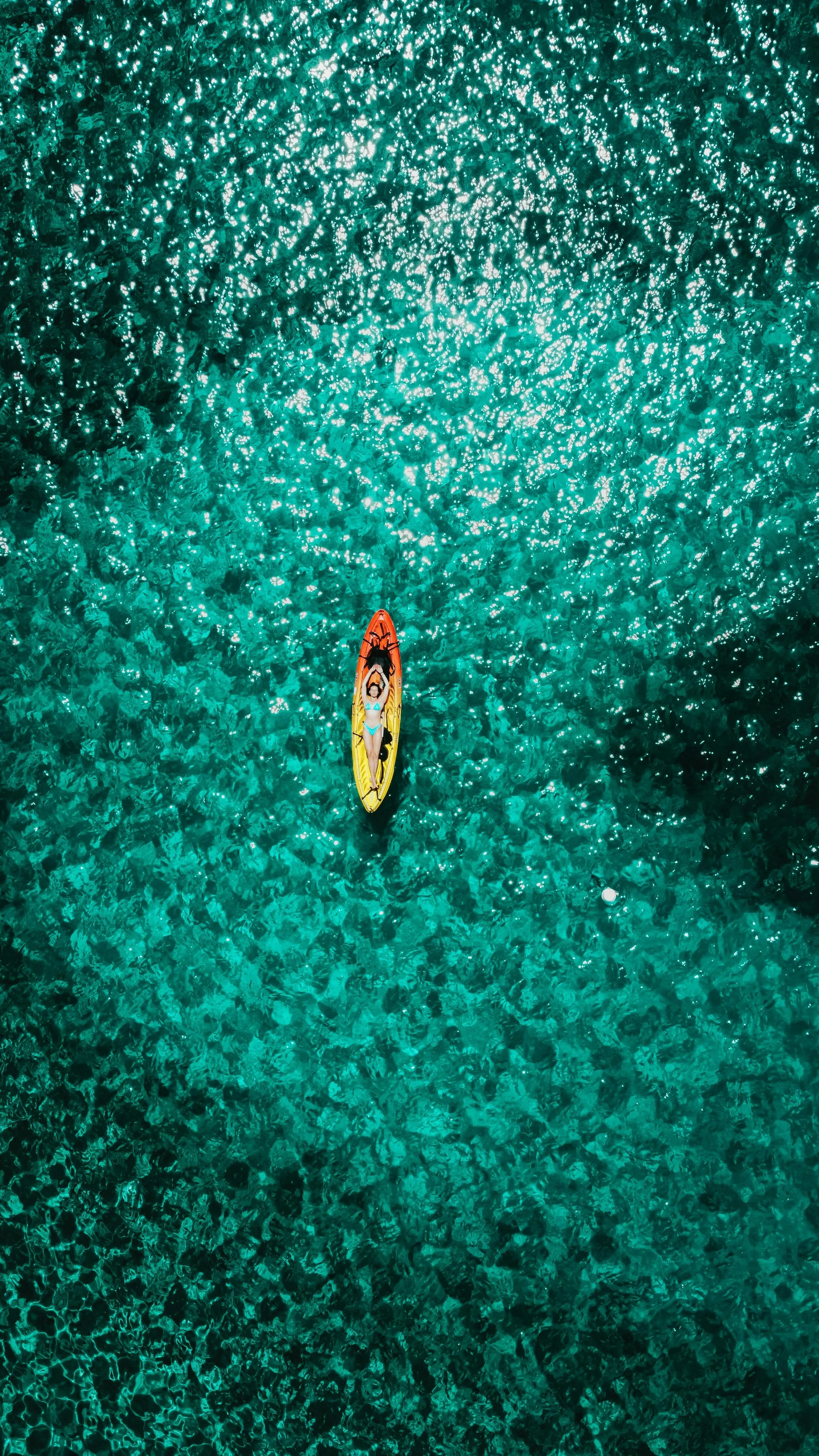Woman Relaxing on a Surfboard floating in Green Water · Free