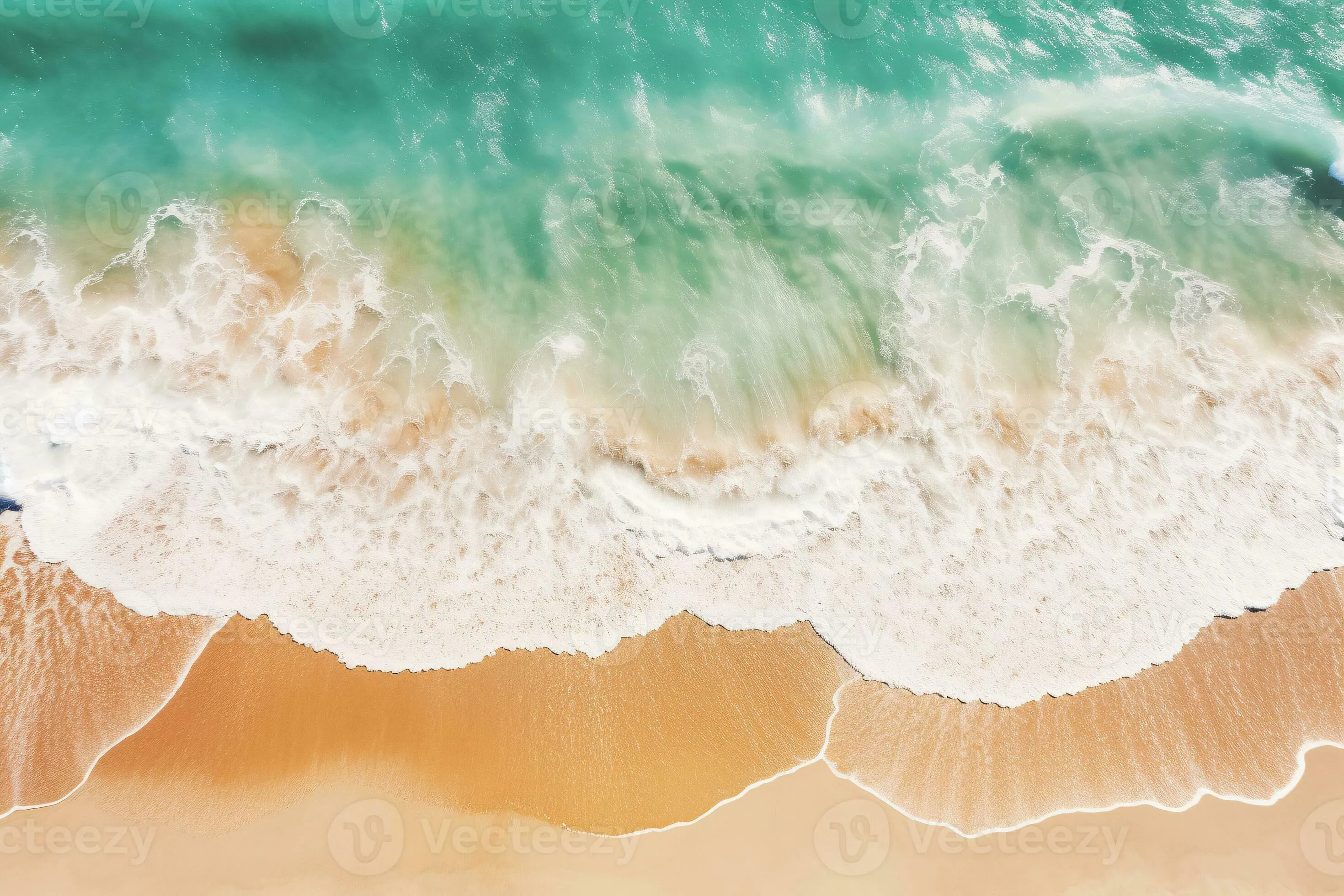 Aerial view of golden sand beach by the sea with emerald green sea water. Summer vacation on tropical paradise beach concept. Ripple of water splash on sandy beach. Summer vibes