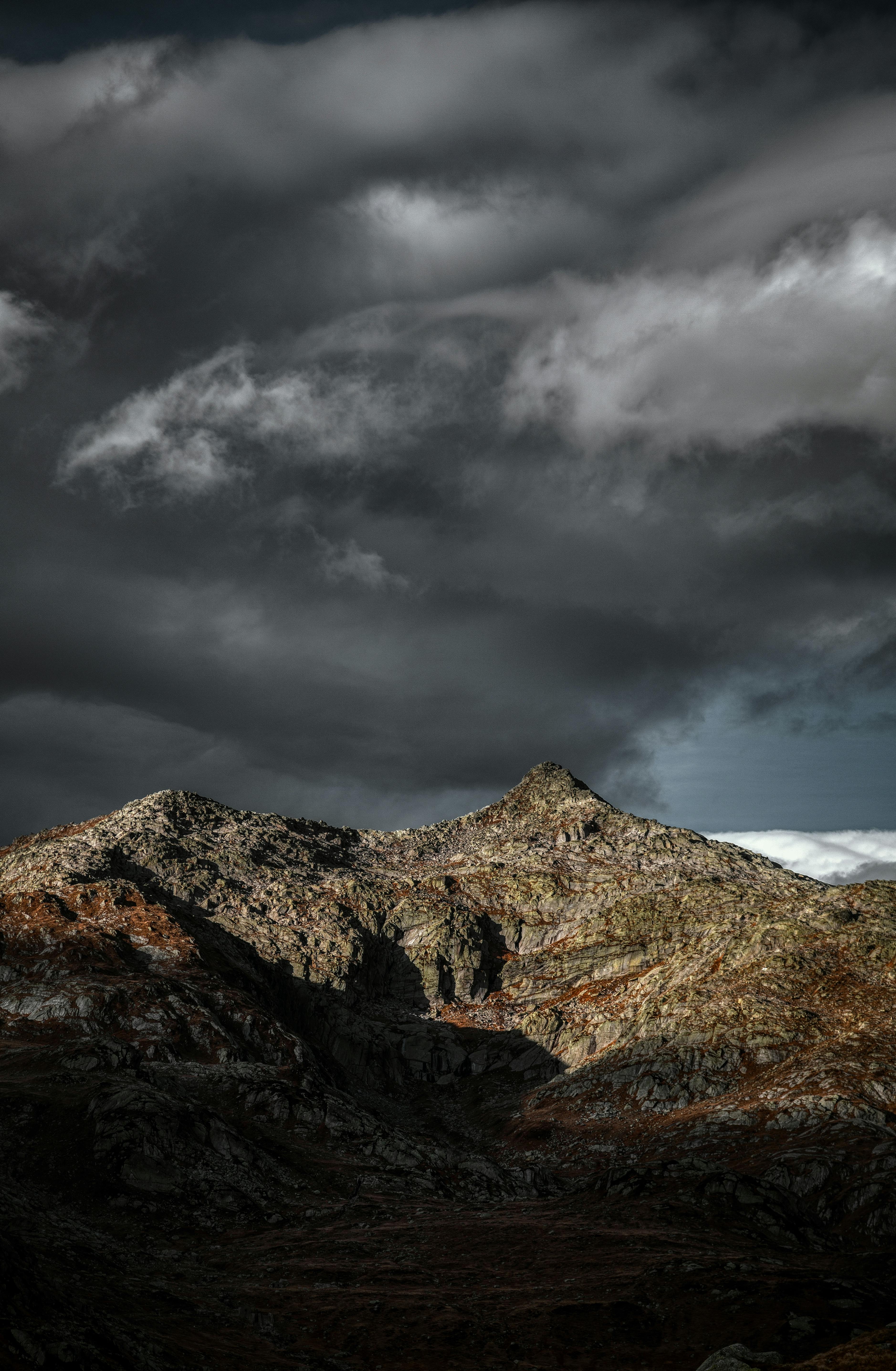Brown Mountain Under Dark Clouds and Gray Sky · Free