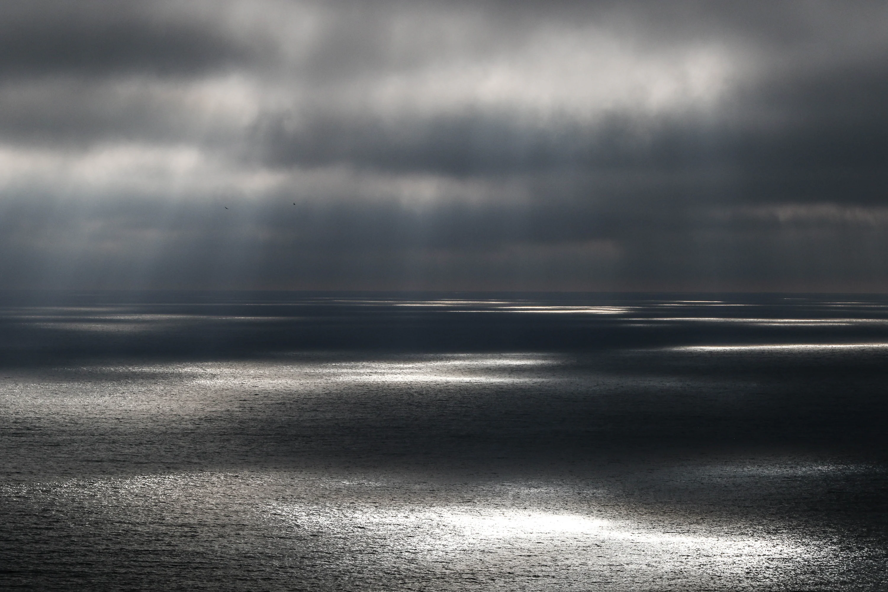 Body of water under gray cloudy sky photo
