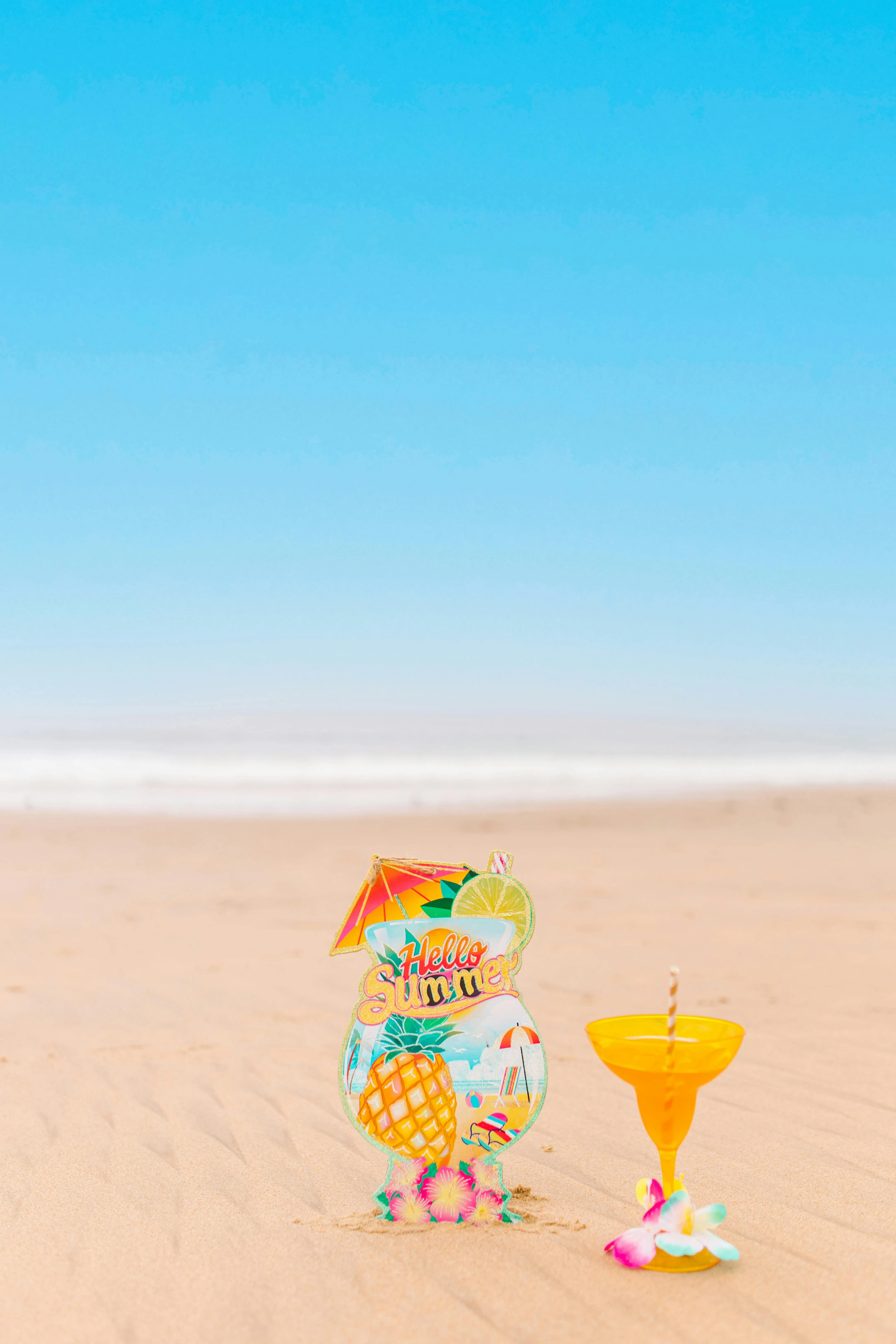 Yellow Cocktail Glass on Beach sand · Free