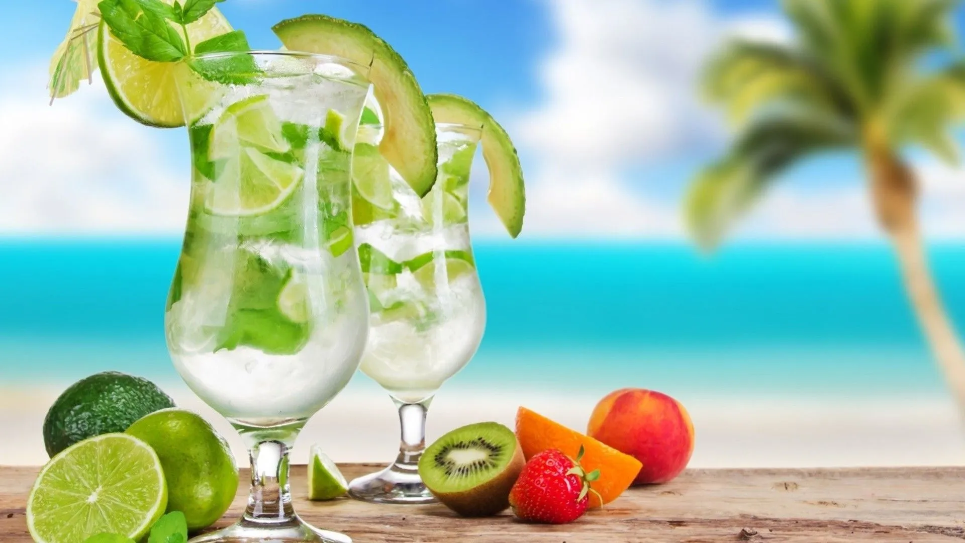 Tropical drinks in glasses and fruits