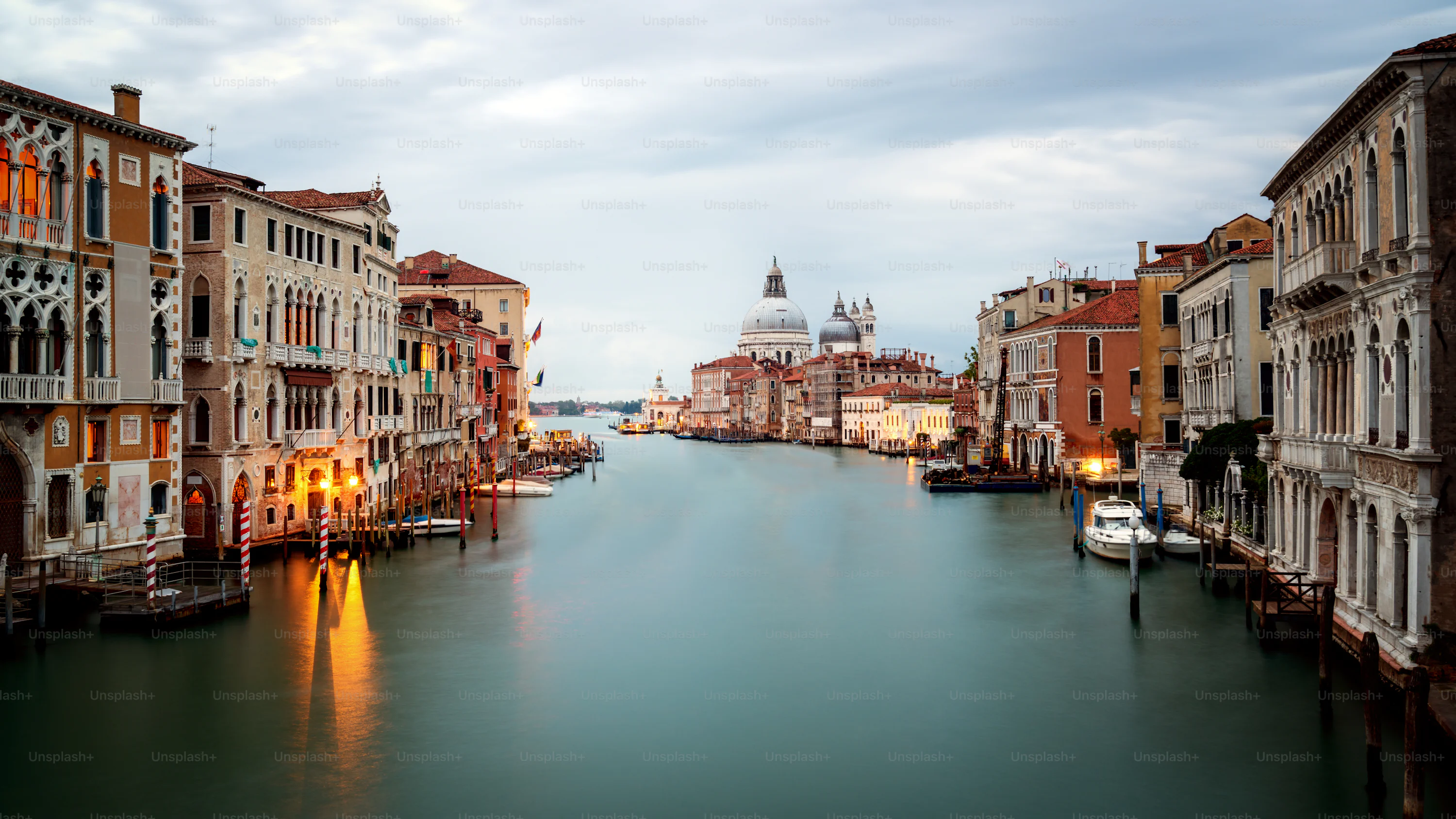 The sun is setting over the water in venice photo
