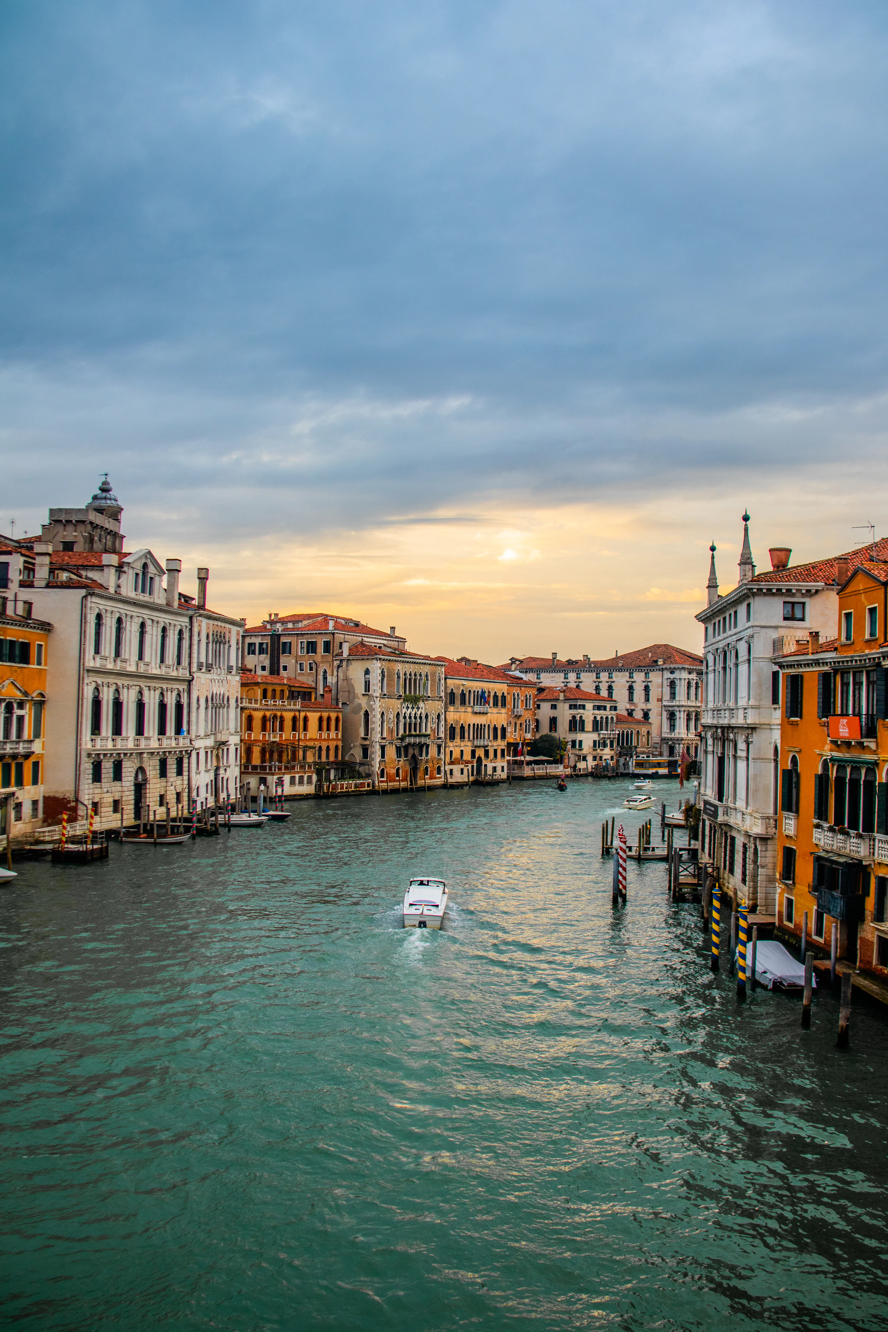 The sun is setting over the water in venice photo