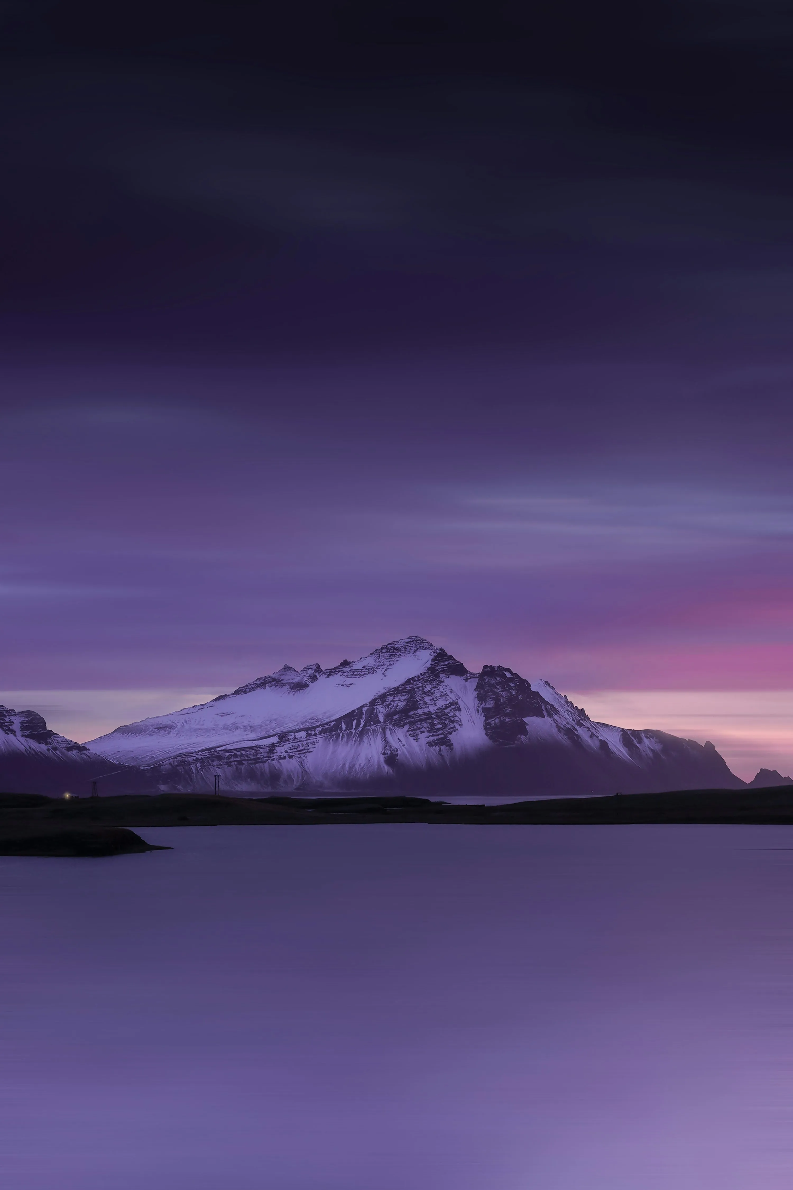 A snowy mountain with a purple sky photo