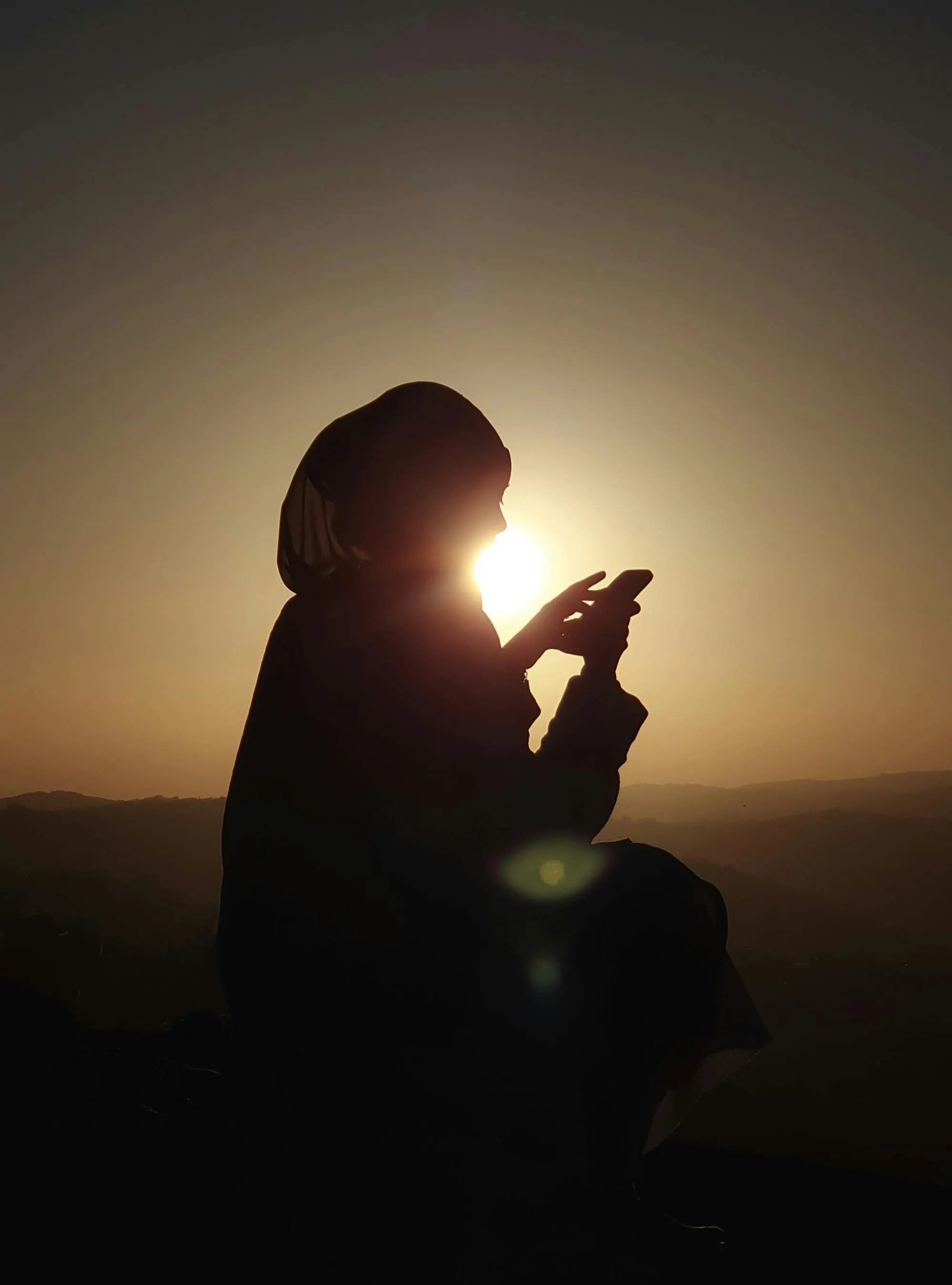 Silhouette of Woman in Hijab at Sunset · Free