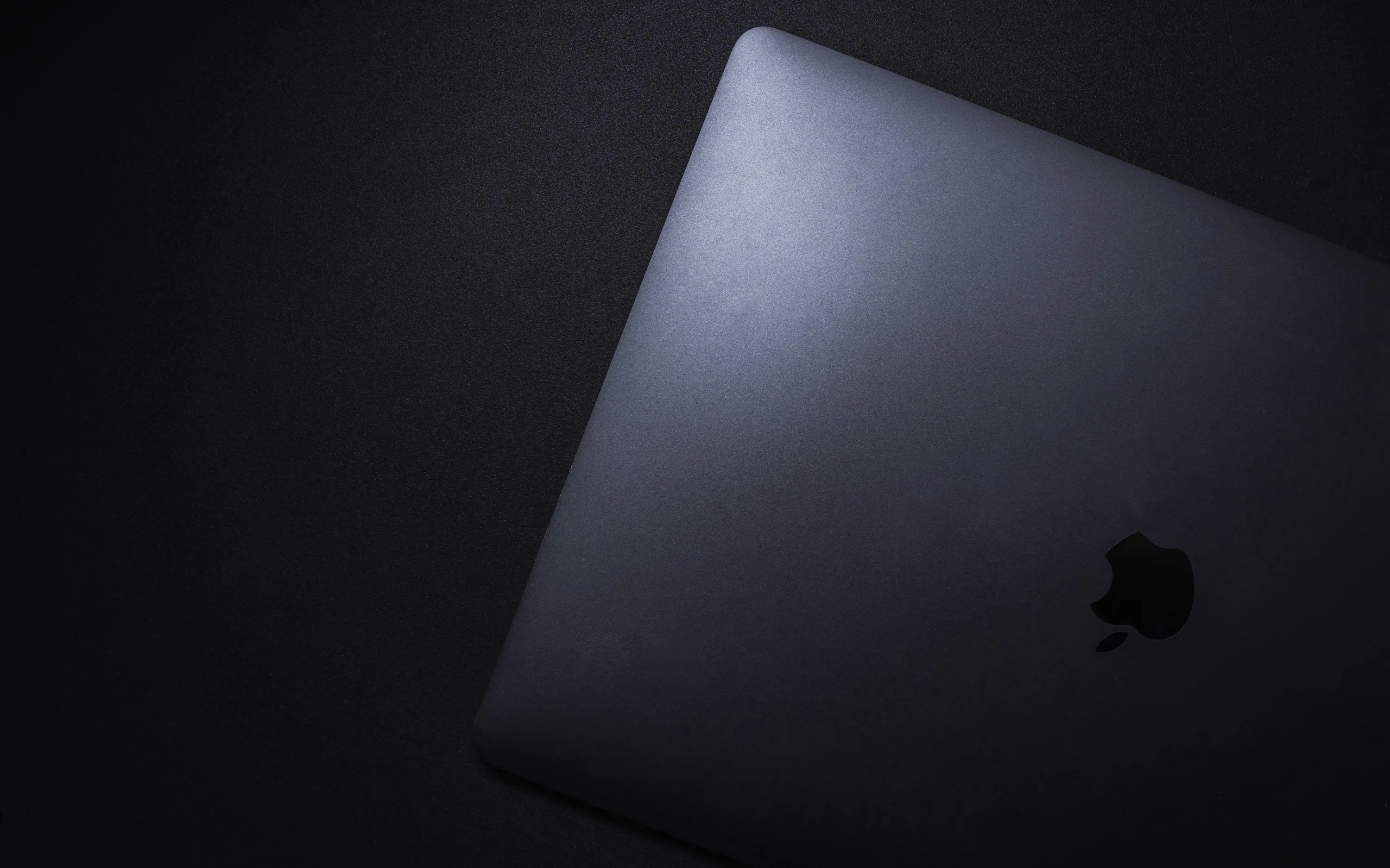 Silver macbook on black textile photo